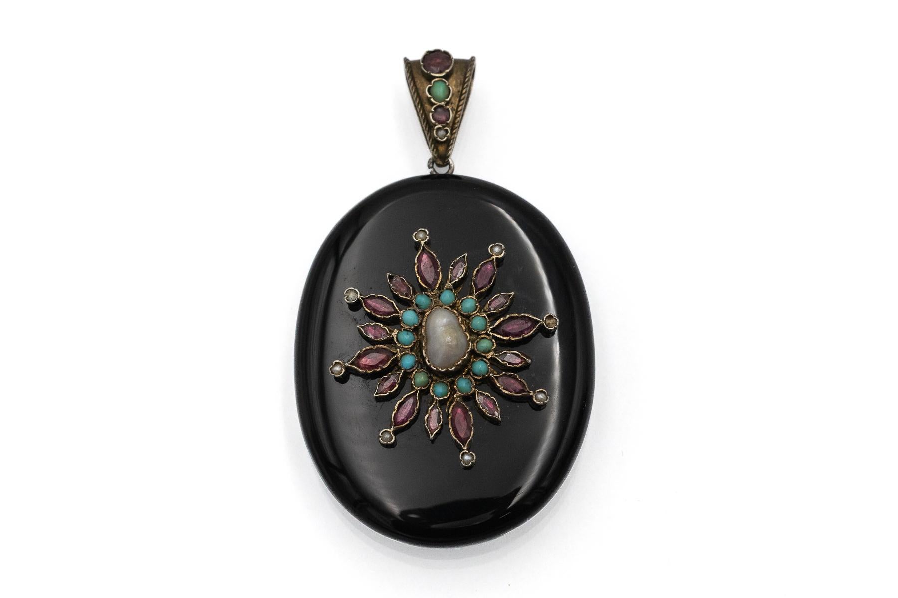 Antique onyx locket with pearls, garnets, and turquoises.

This unique antique locket, a secret locket, is made of onyx. This decorative locket is set with 18 beautiful red-pink garnets on the front, weighing approximately 2.00 ct. The pendant is