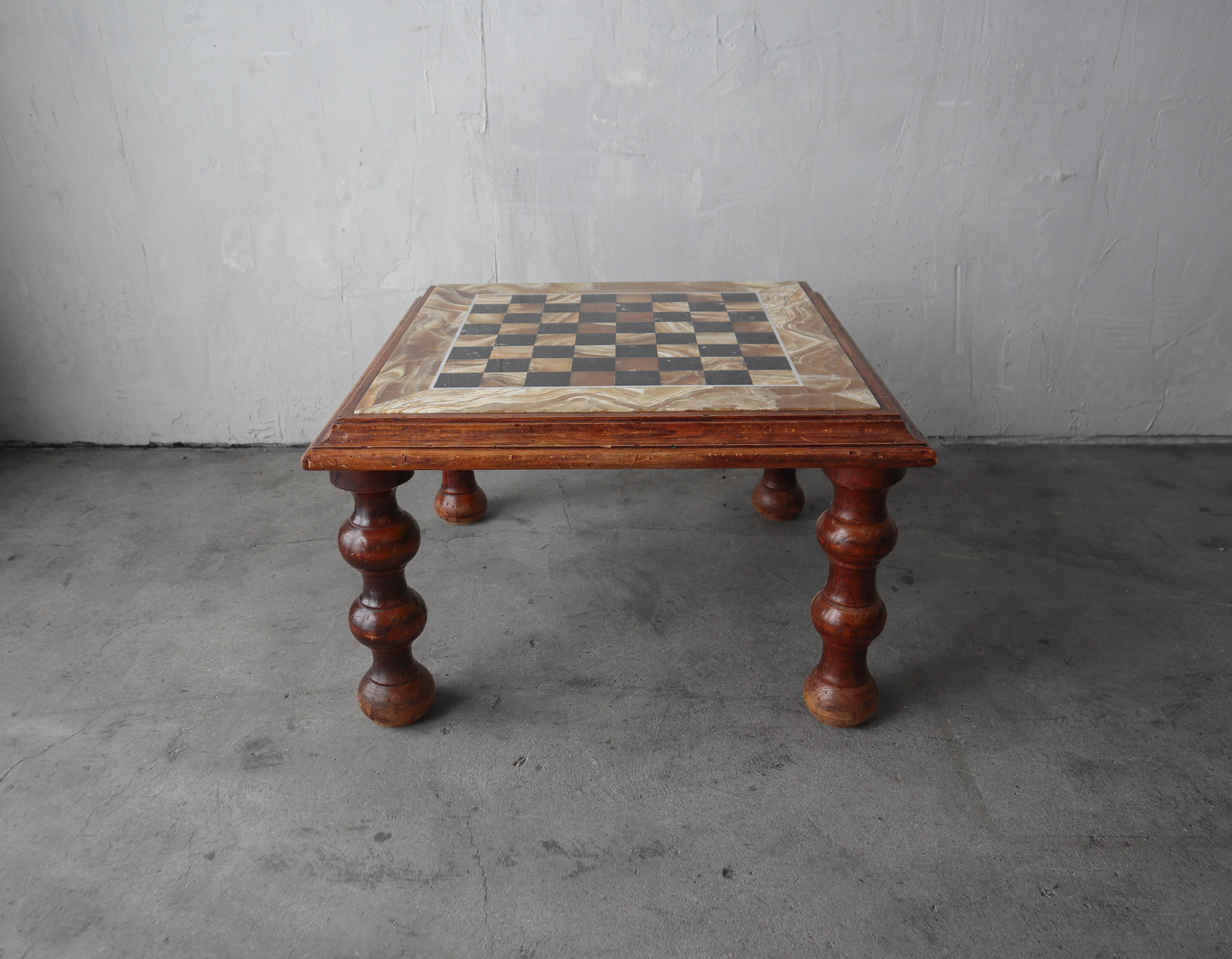 Gorgeous antique checkerboard game table.  Love the hand turned legs and beautiful honey onyx.  A truly unique piece.  Table is coffee table height making it the perfect table between 2 chairs.

The table is in excellent vintage with only minimal