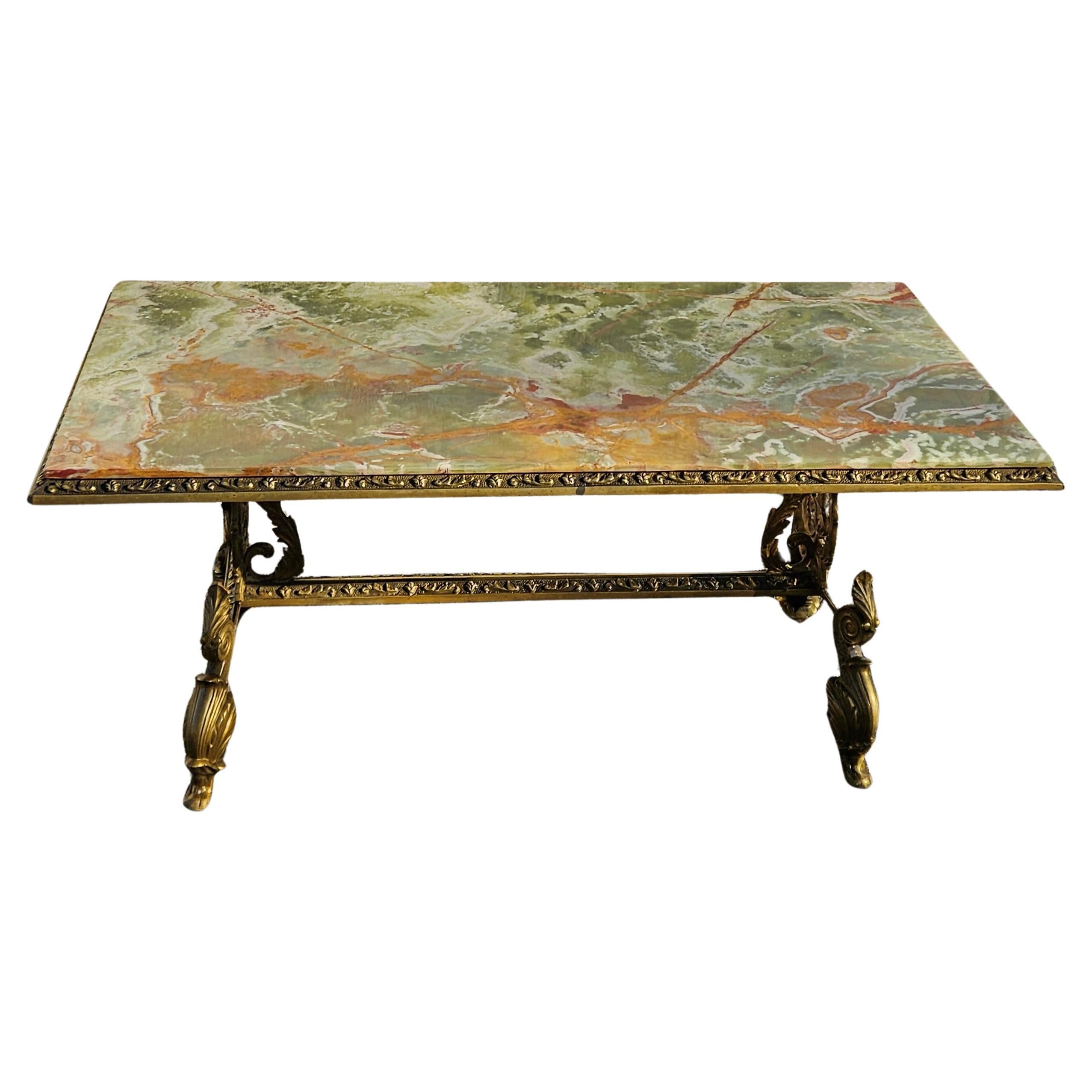 Experience the grandeur of the 1930s with this French antique coffee table, boasting a green onyx marble top and a baroque-style bronze frame. The tabletop's elegant shape is adorned with natural patterns, displaying a vibrant mix of emerald, jade