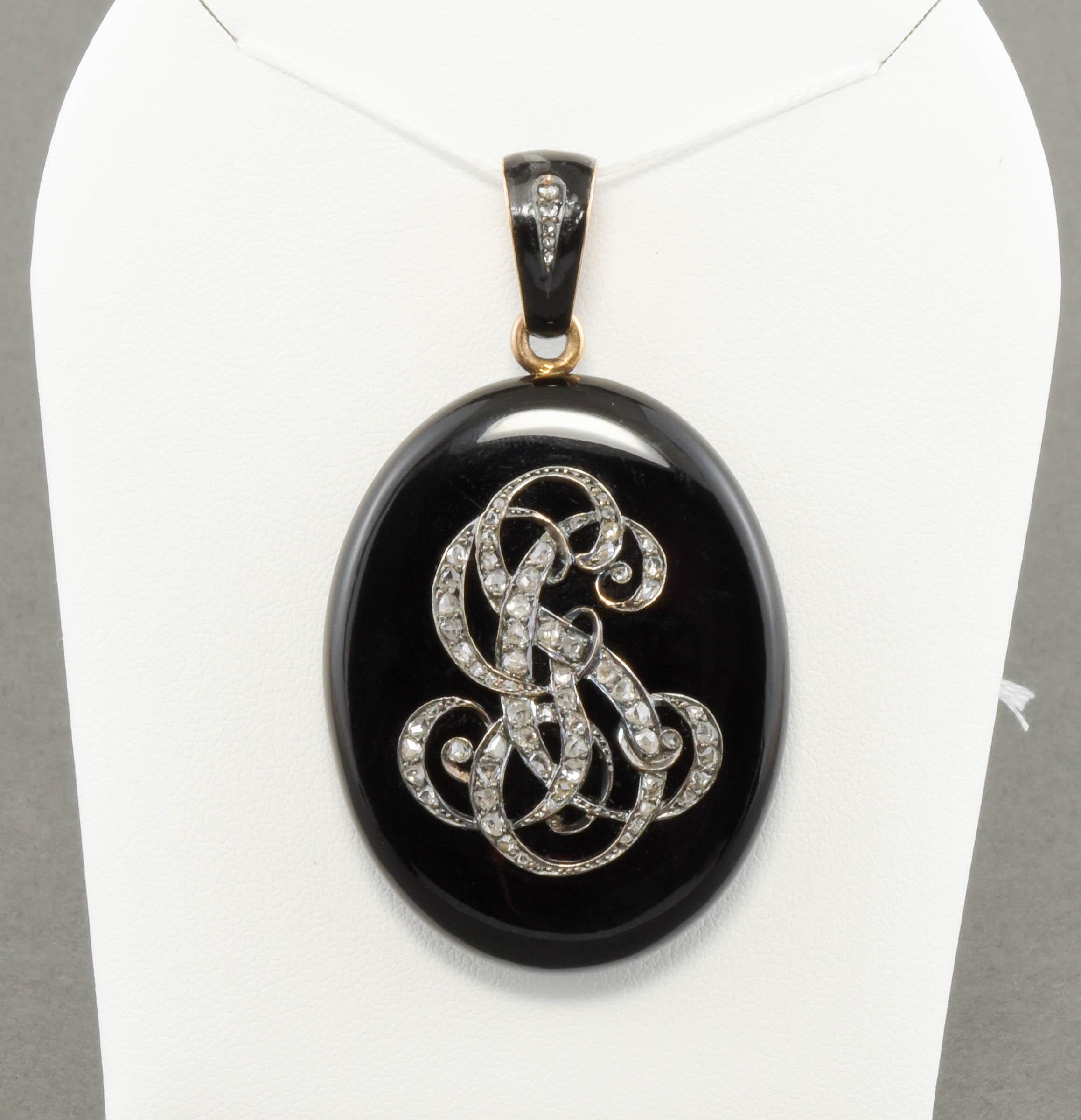 This superb Victorian period locket is carved from a solid piece of glossy black onyx with an applied gold & silver monogram of three initials set with very sparkly old rose cut diamonds.  The reverse has a glazed compartment to hold a cherished