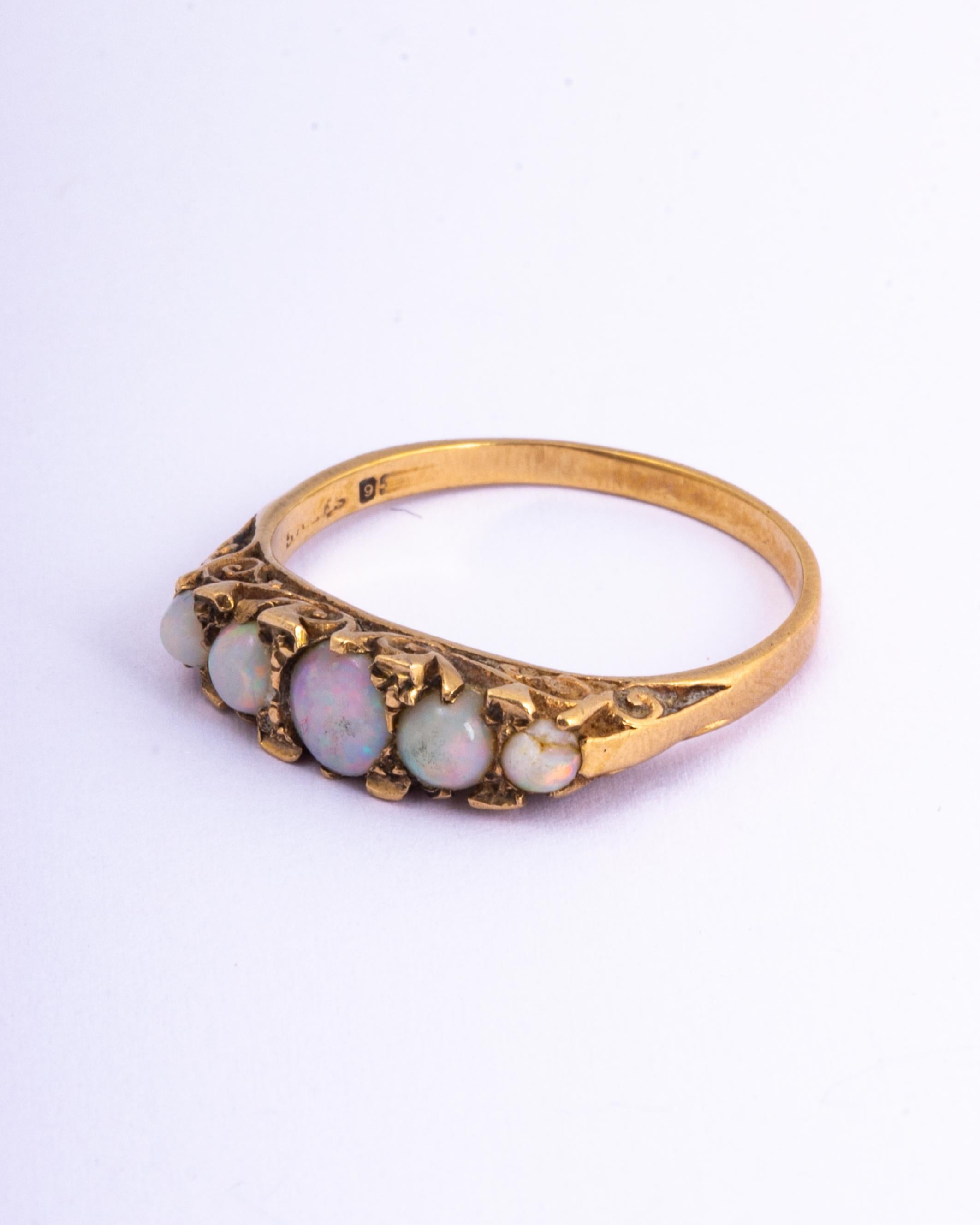 The opals in this ring are gorgeous and throw some great colours. They are set upon the 9ct gold ring in claw settings. Made in Birmingham, England. 

Ring Size: N 1/2 or 7 
Band Width: 6.5mm 
Height Off Finger: 5mm

Weight: 3.3g