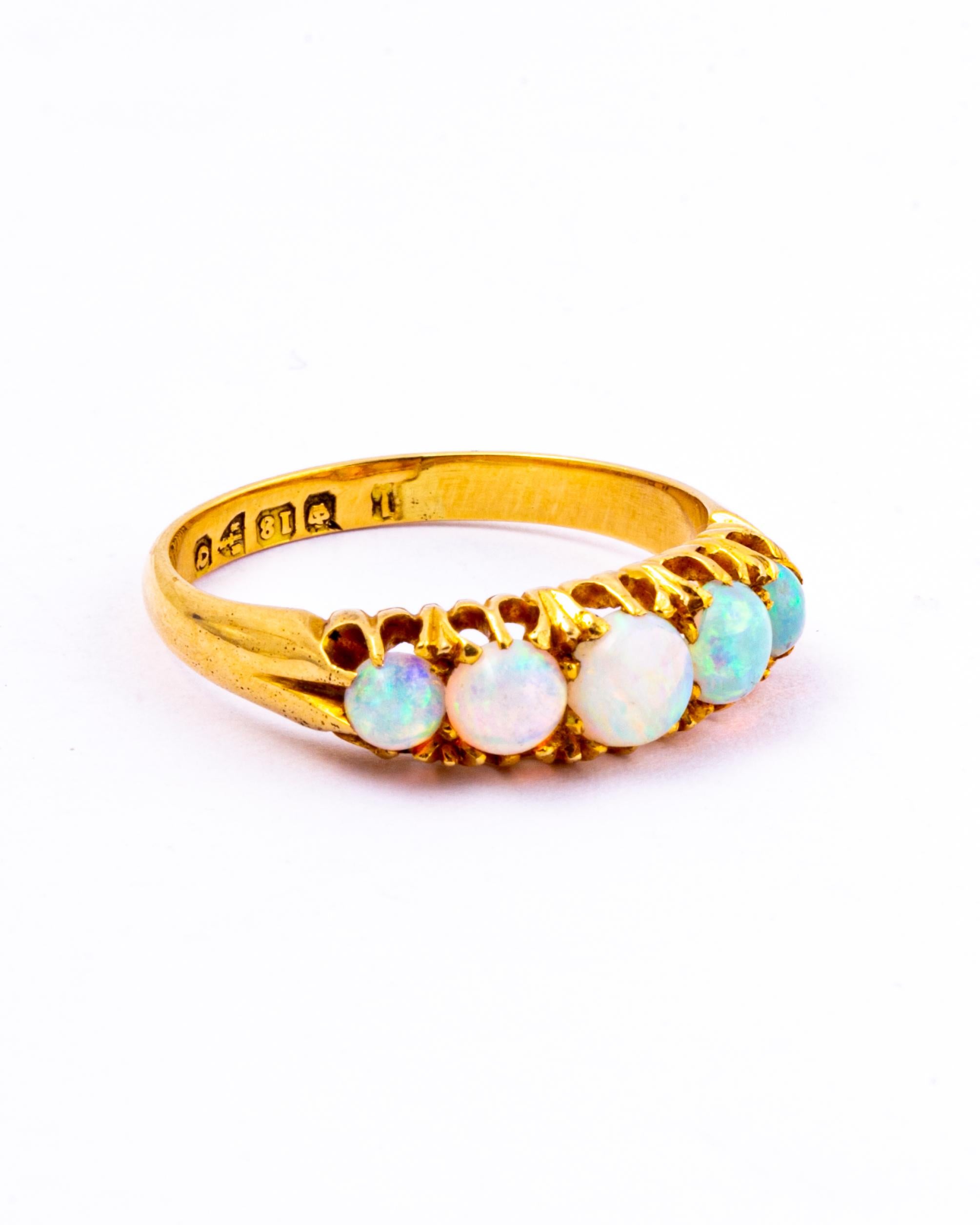 The five oval cabochon opals set in this ring are just beautiful! They have flecks of every colour and are mesmerising. The stones are set in 18ct gold claw settings and the ring has a chunky feel to it. 

Ring Size: Q or 8 1/4
Band Width: 5mm