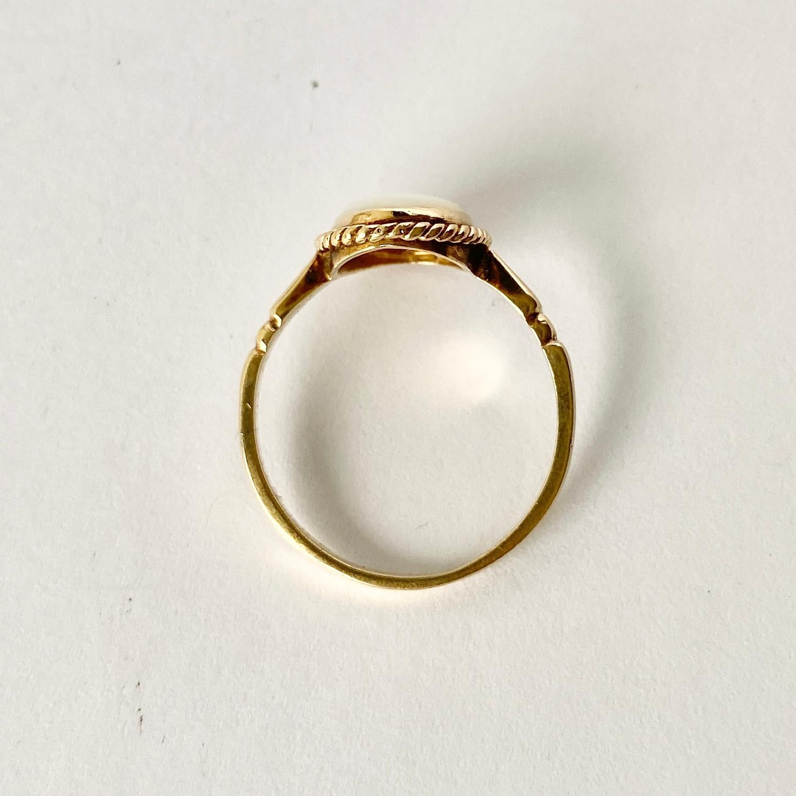 This pale opal has flecks of colour through it when moved around in the light. Surrounding the stone is rope twist detail. 

Ring Size: M 1/2 or 6 1/2 
Stone Dimensions: 9x7mm 

Weight: 1.8g