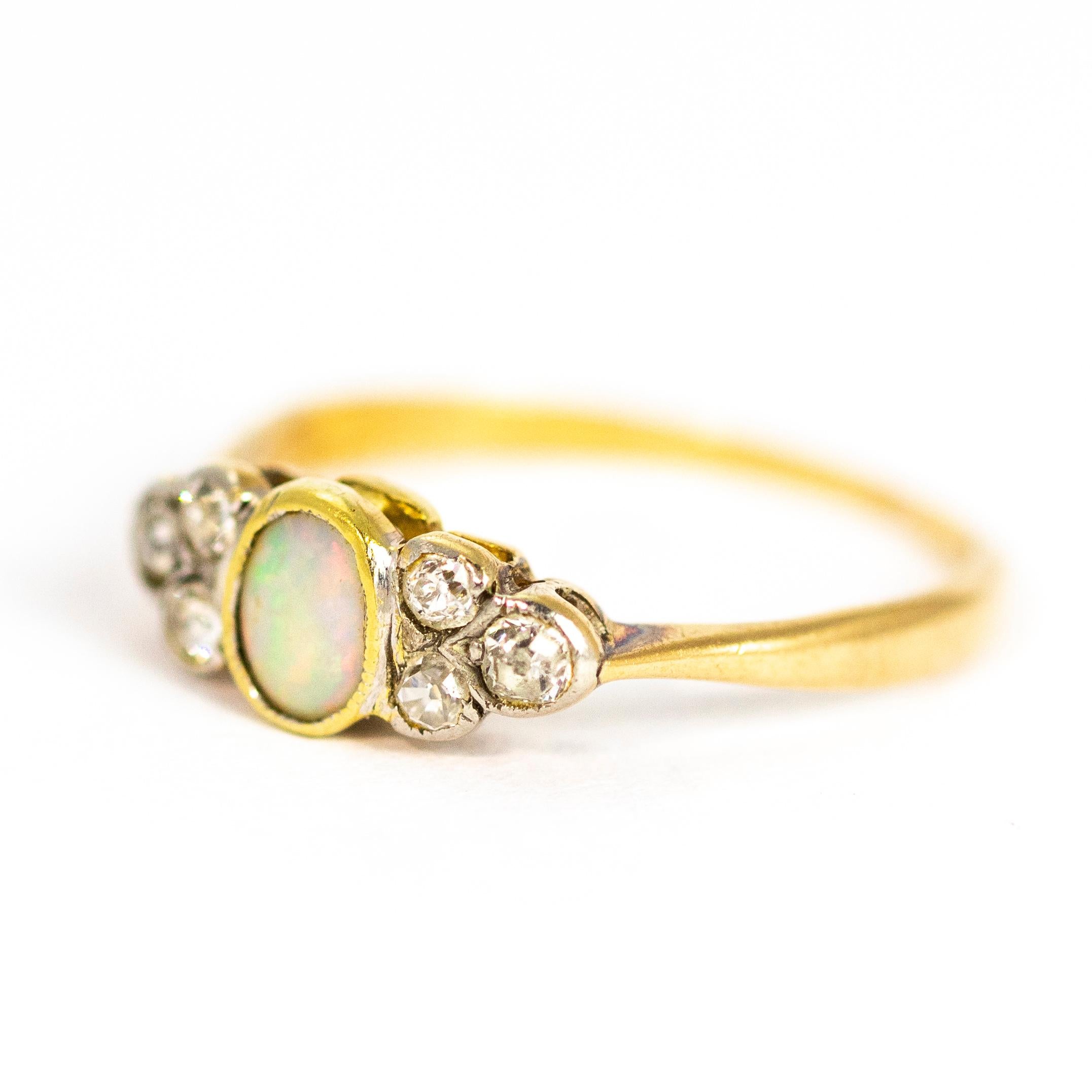 This beautiful and delicate opal ring also boasts six diamonds. The oval shaped opal is sandwiched between a cluster of three diamonds each side. Modelled out of 18ct gold.

Ring Size: L 1/2 or 6
Opal Dimensions: 4.5mm x 5mm