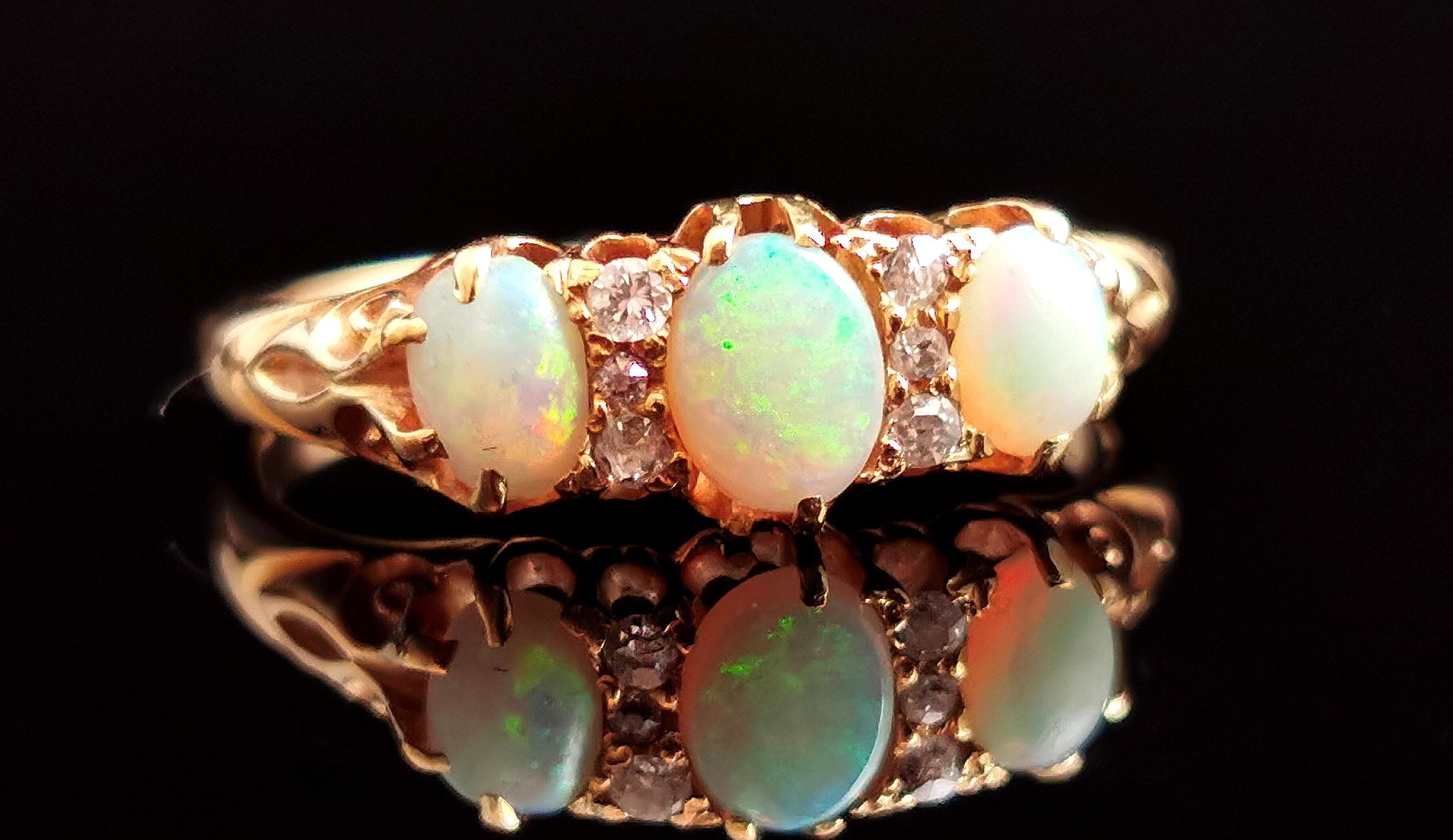 An gorgeous antique, Edwardian era opal and Rose cut diamond ring.

A rich 18kt yellow gold band with a boat head style setting and decorative engraved shoulders.

The face is set with three beautiful opal cabochons, the largest to the centre with a