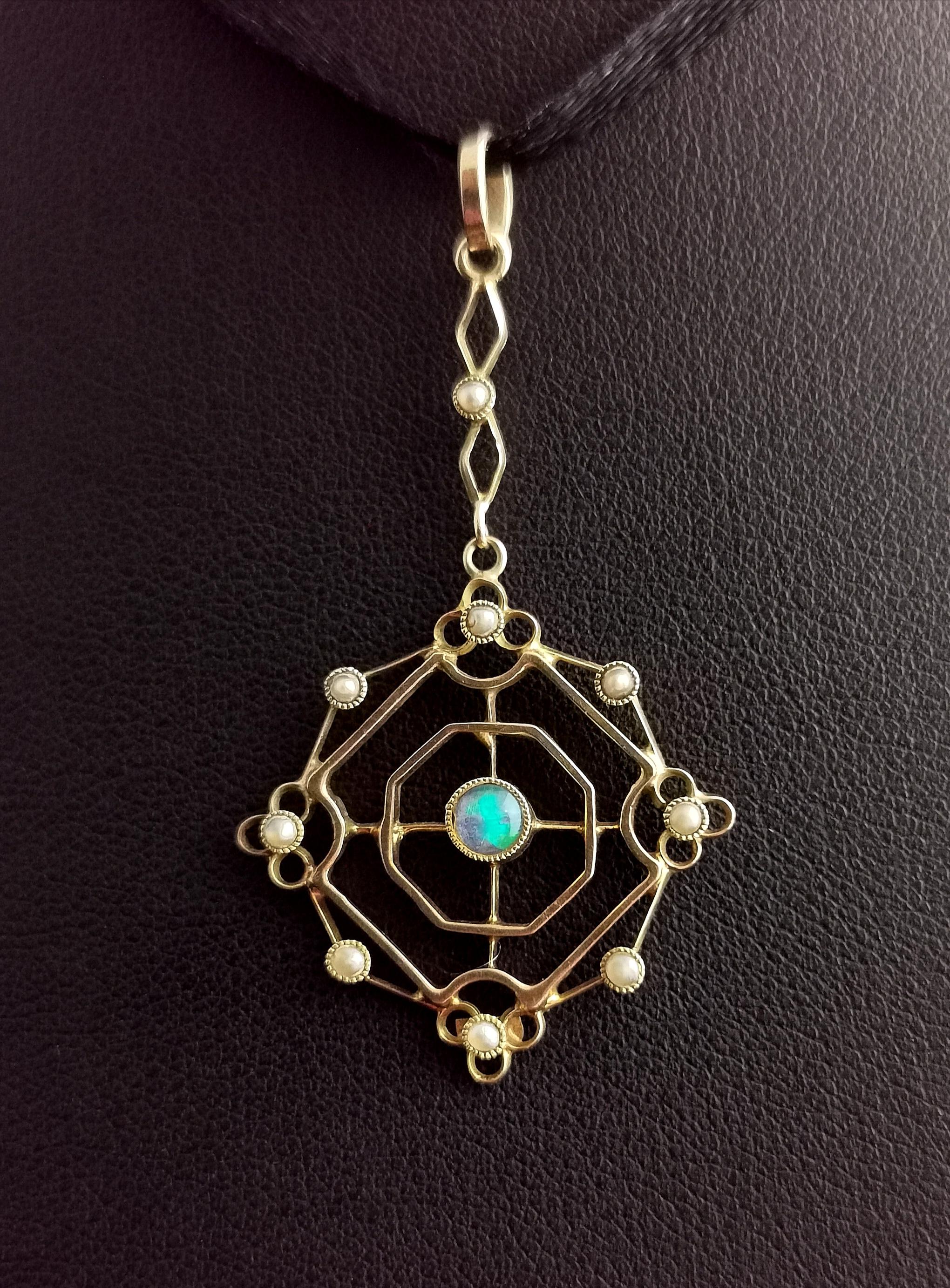 A pretty and delicate antique, Art Nouveau Opal and seed pearl pendant.

It is a pretty geometric shaped pendant with an openwork design and a decorative integral drop bale, the outer edge of the pendant is set with tiny creamy seed pearls as is the