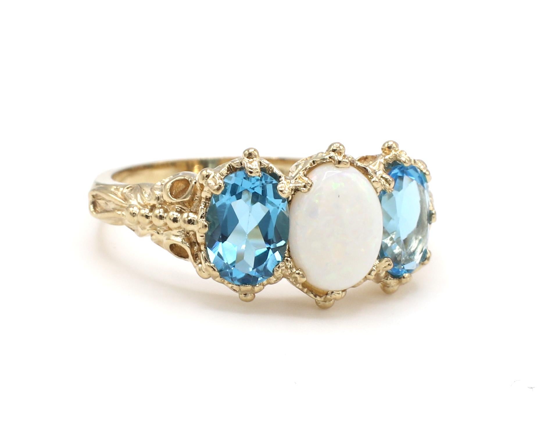 Antique Yellow Gold Opal & Blue Topaz 3 Stone Band Ring 
Metal: 10k yellow gold
Weight: 4.26 grams
Gemstones: Blue topaz and opal
Width: 10.5 - 2mm
Size: 8 (US)