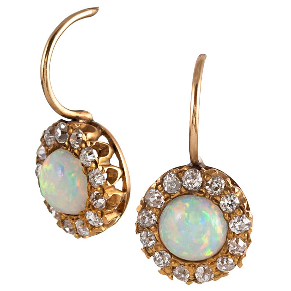 14 karat yellow gold frames a cabochon of opal and antique cut diamonds. These sweet antique treasures retain their original ear wires and measure just ¾ of an inch long. Prepare to be charmed!