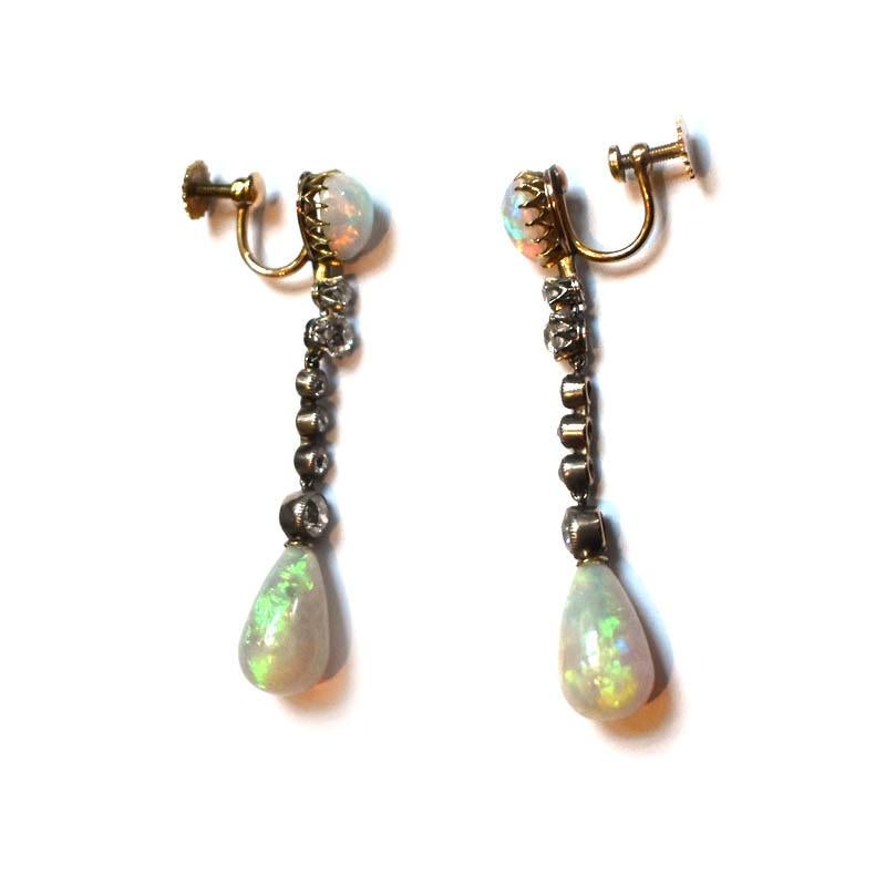 A pair of antique opal drop earrings, with pear shape cabochon opal set tops, with two old-cut diamonds, set in white gold, crown, claw settings, with three small and one larger old-cut diamonds, in millegrain edged, silver-upon-gold, rub over