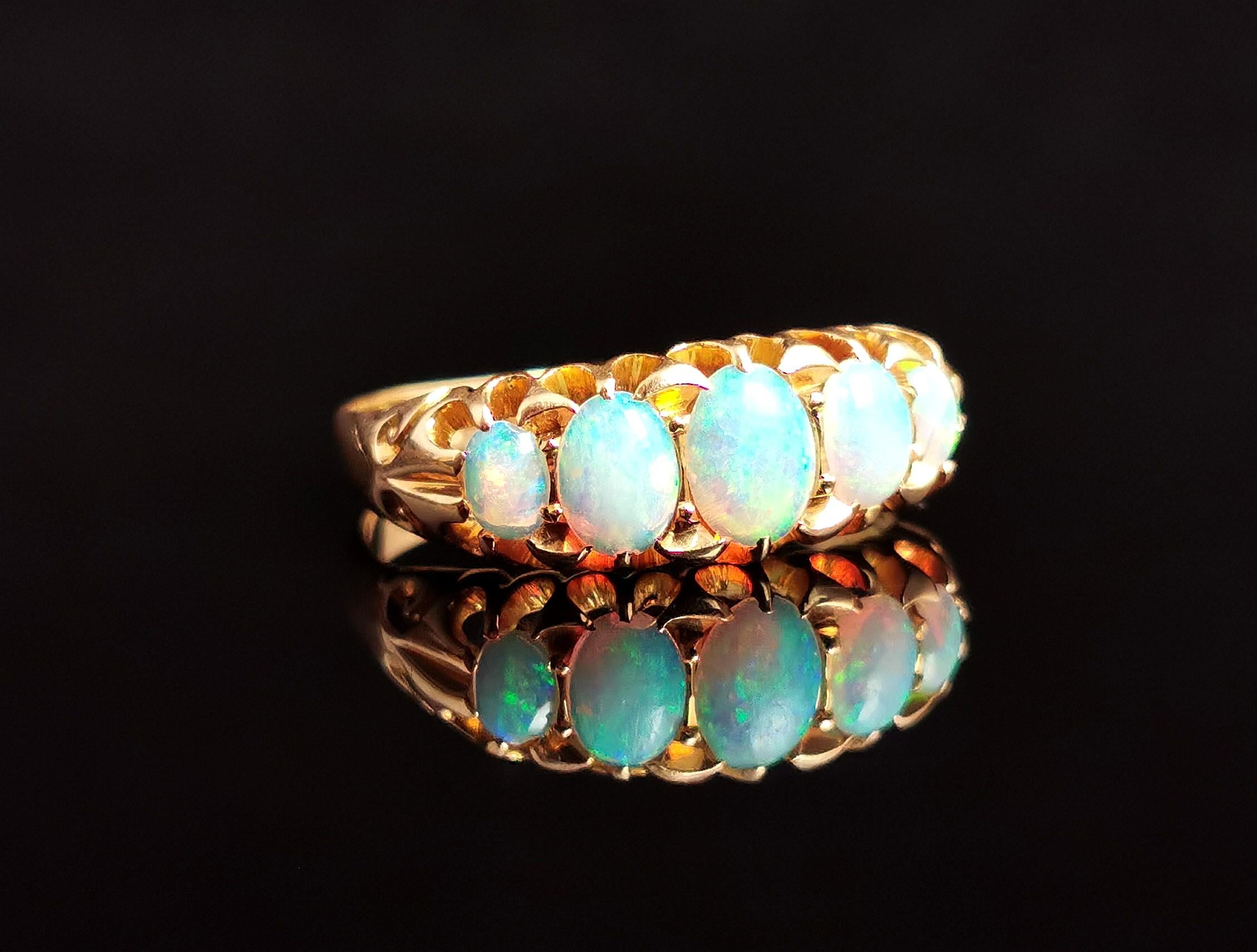An attractive antique, Edwardian era opal five stone ring.

A rich 18kt yellow gold band with a boat head style setting.

The face is set with five beautiful oval opal cabochons, graduating in size from the centre opal.

The opals are just stunning