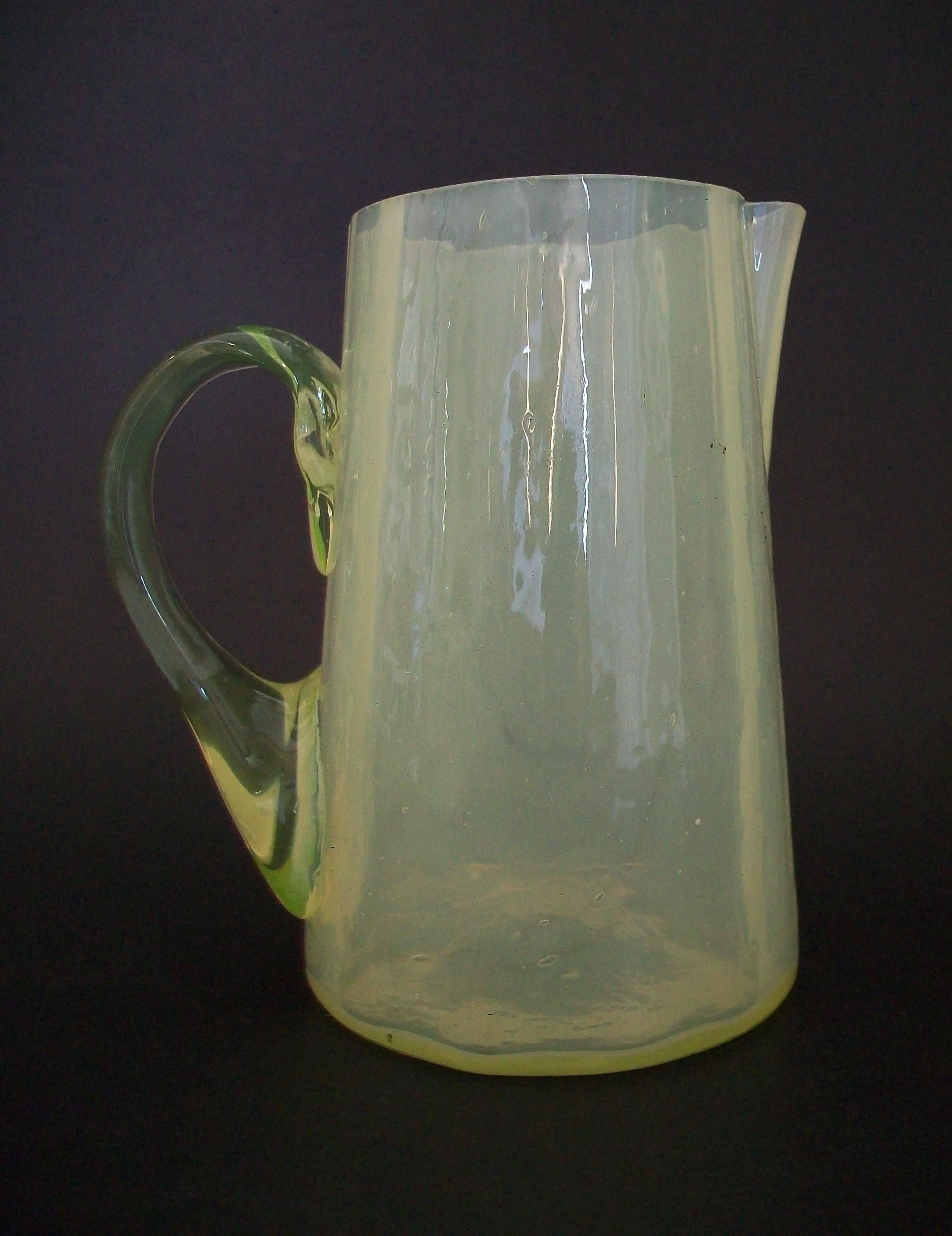 Antique Americana opalescent Vaseline glass cream pitcher - hand made Vaseline glass handle - unsigned - United States - circa 1900.

Excellent antique condition - couple of minor 'flea bites' to the rim - no loss - no cracks - no restoration -