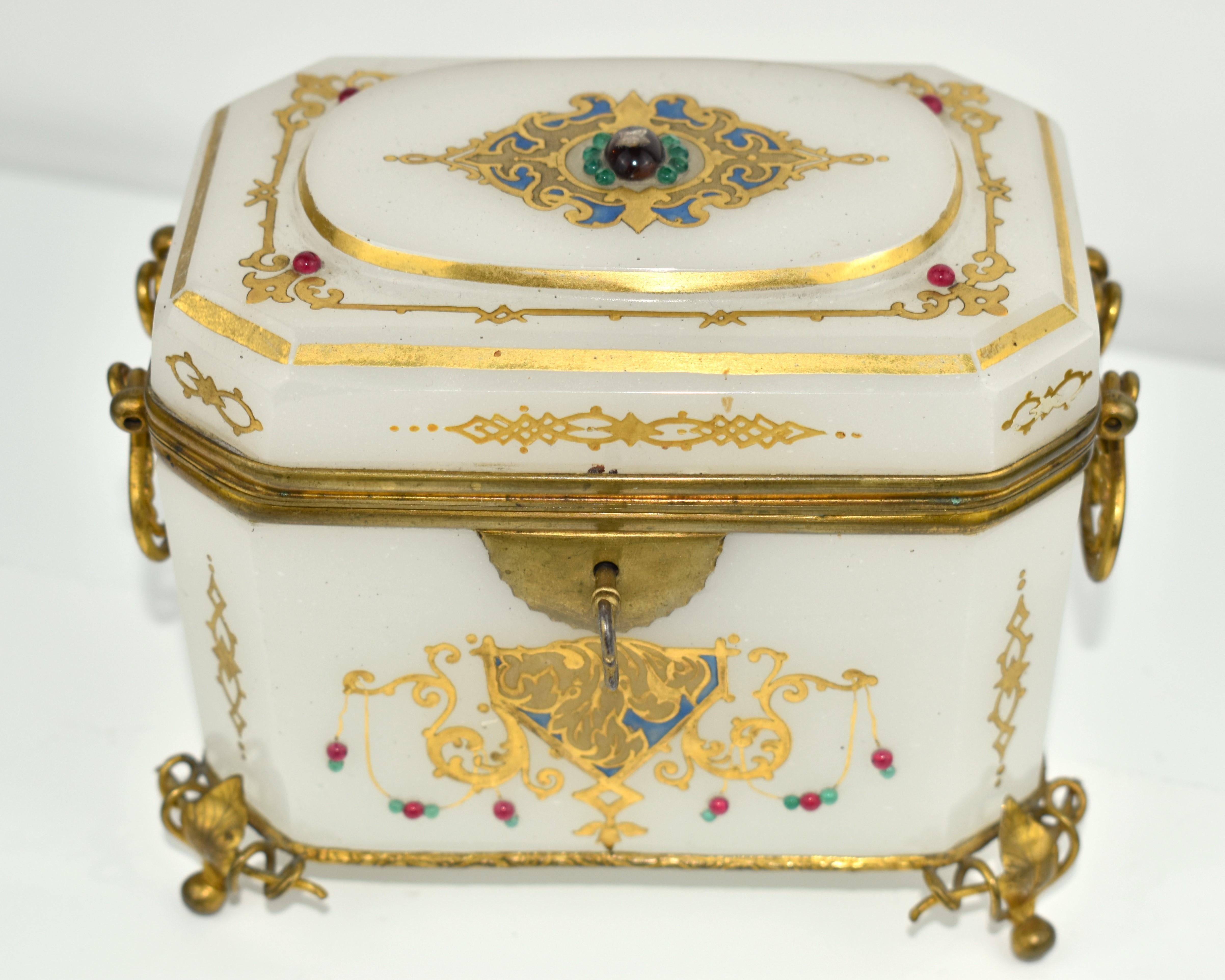 Very Rare Milky White Jewelry Box with Hinged Bronze Mounts

Standing on Dore Bronze Feet and Matching Swinging Handles

Lid and Base are Both Framed in Bronze

Generously Enameled all Around with Colourful Beads and Gilding Decoration

Original Key