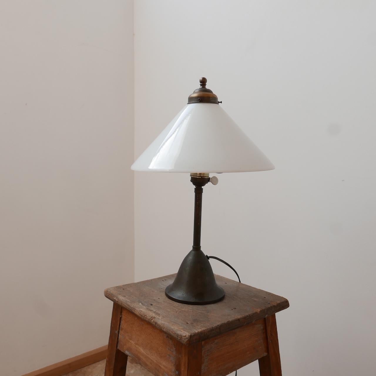 An antique table lamp. 

The original opaline glass shade has been retained but it could be replaced with something more contemporary. 

Holland, c1910. 

Since re-wired and PAT tested. 

Some knocks and dings commensurate with age.