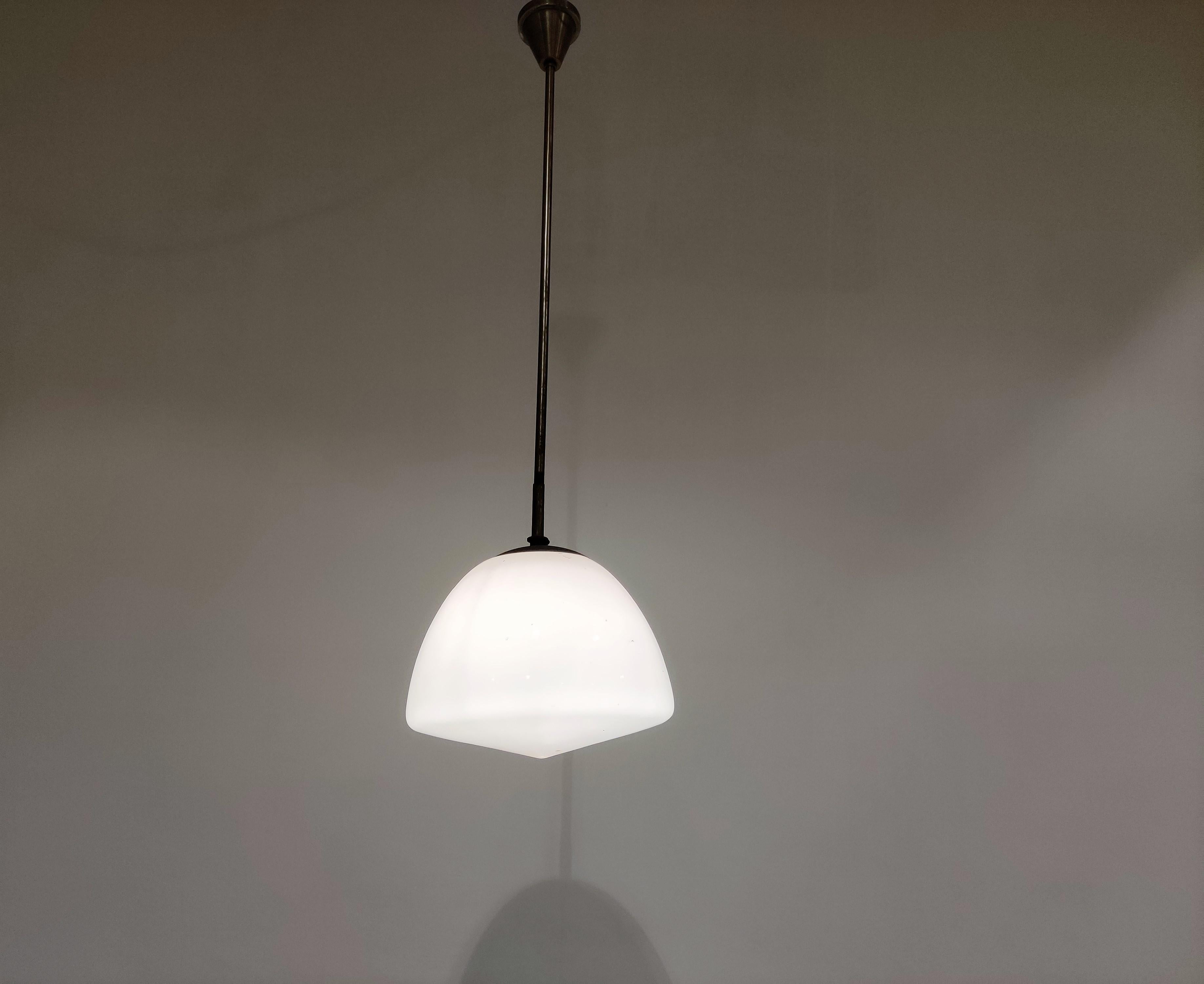 Antique Art Deco hallway pendant lights.

These lamps are very typical for the Art Deco era and were widely used to be hung in hallways, offices or larger public places.

The lamps have the original shade holders and ceiling caps.

The shade emits a