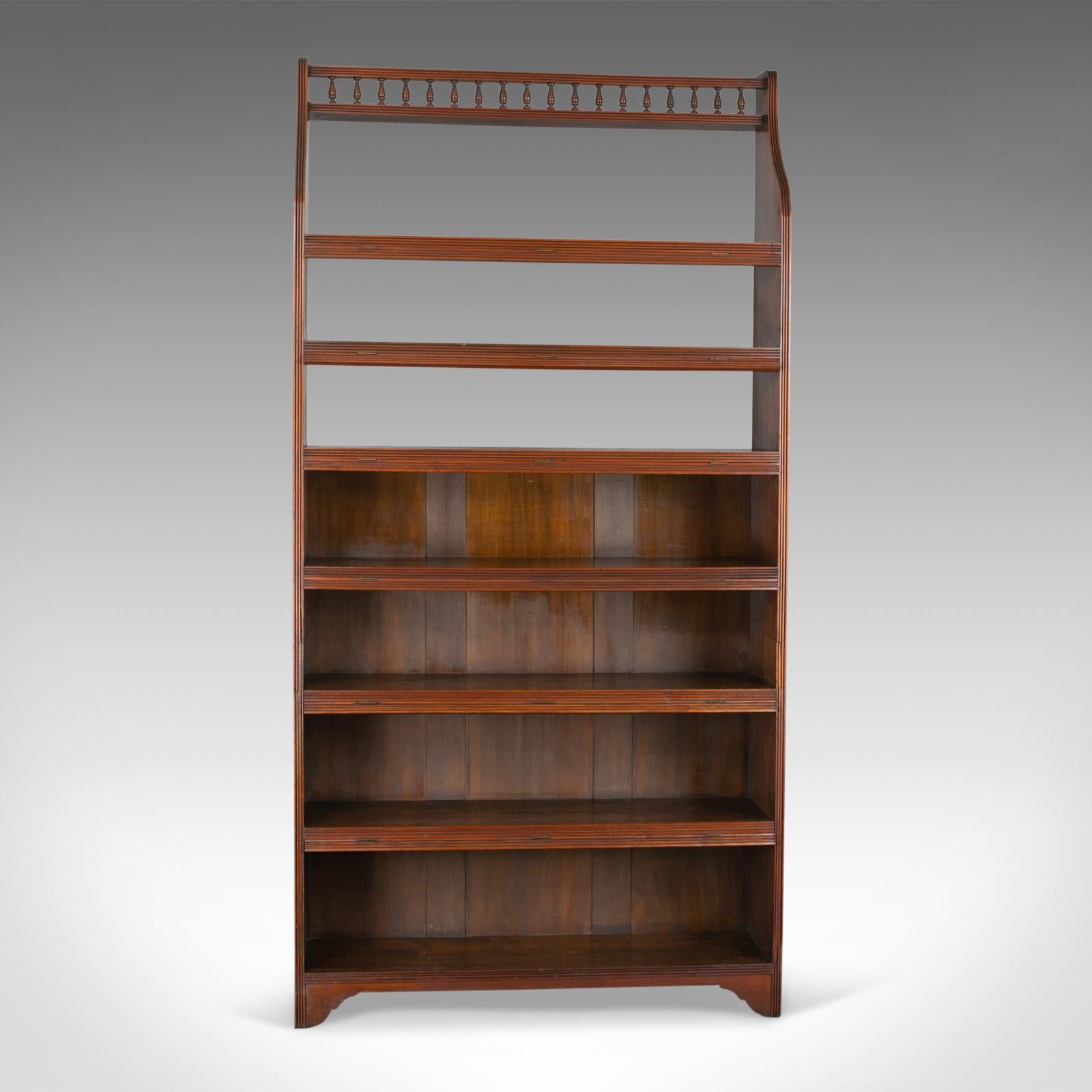 This is an antique open bookcase, tall, English, walnut book shelves. Edwardian, dating to the early 20th century, circa 1910.

Walnut with grain interest in the wax polished finish
Six, graduated shelves featuring hinged dust flaps
Narrow,