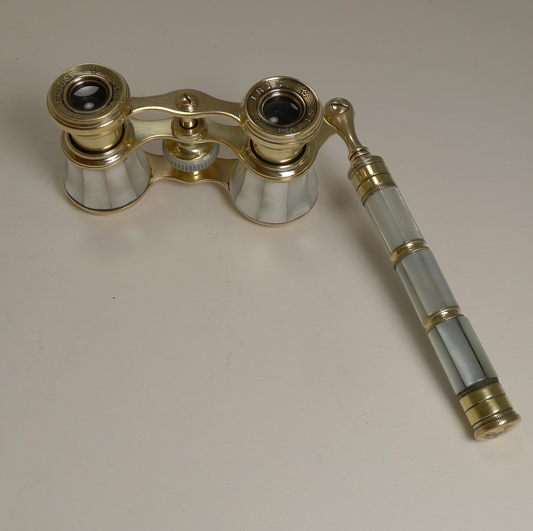 A stunning pair of late Victorian or Edwardian Opera glasses dating to the turn of the century, circa 1900. French in origin, each eye piece is signed, Iris, Paris.

The telescopic lorgnette handle extends from 5