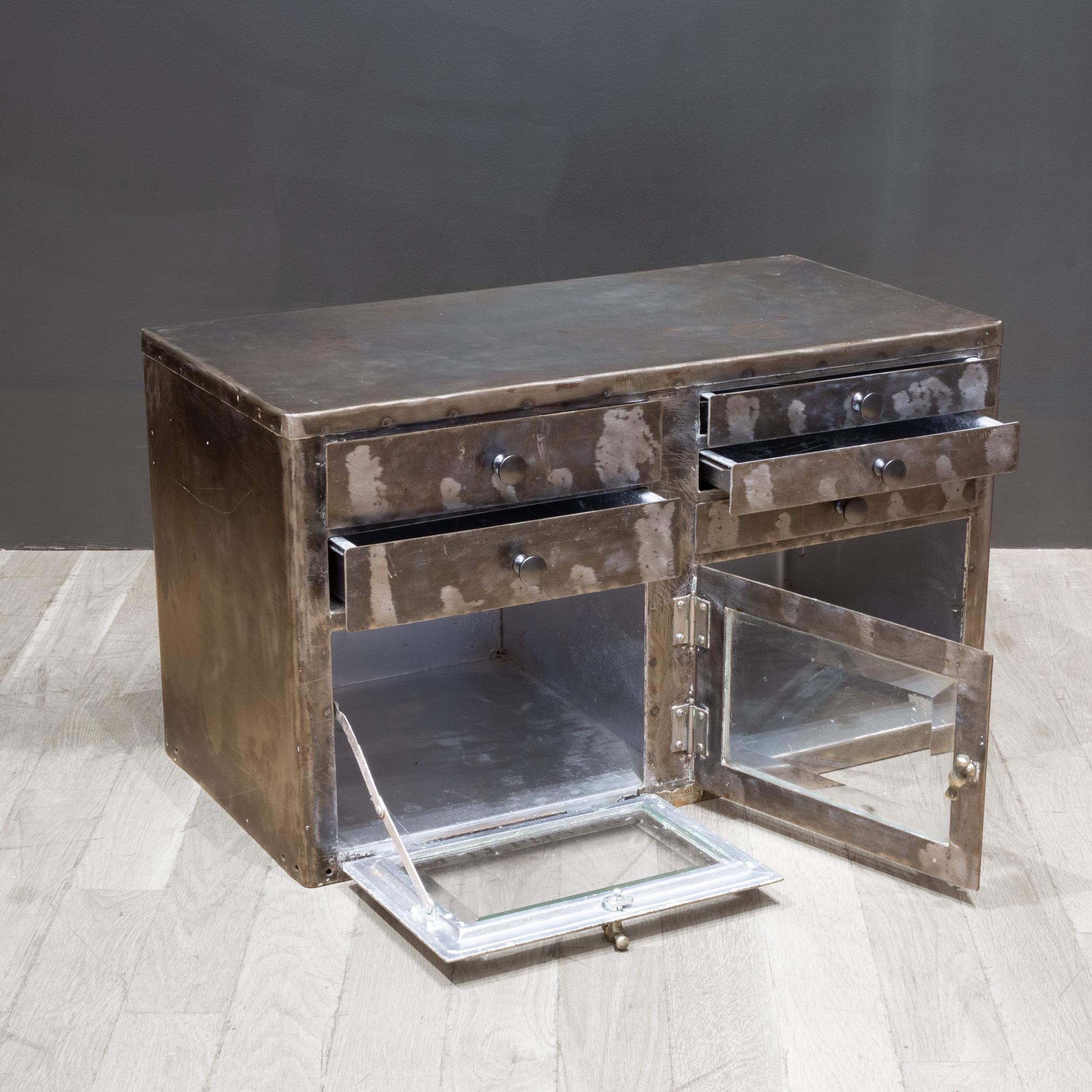 ABOUT

An early 20th century stainless steel hospital operating room supply and instrument cabinet used for foot surgeries. Two large drawers, three smaller drawers and two compartments. Original thick, beveled glass. Brass plated handles. Original