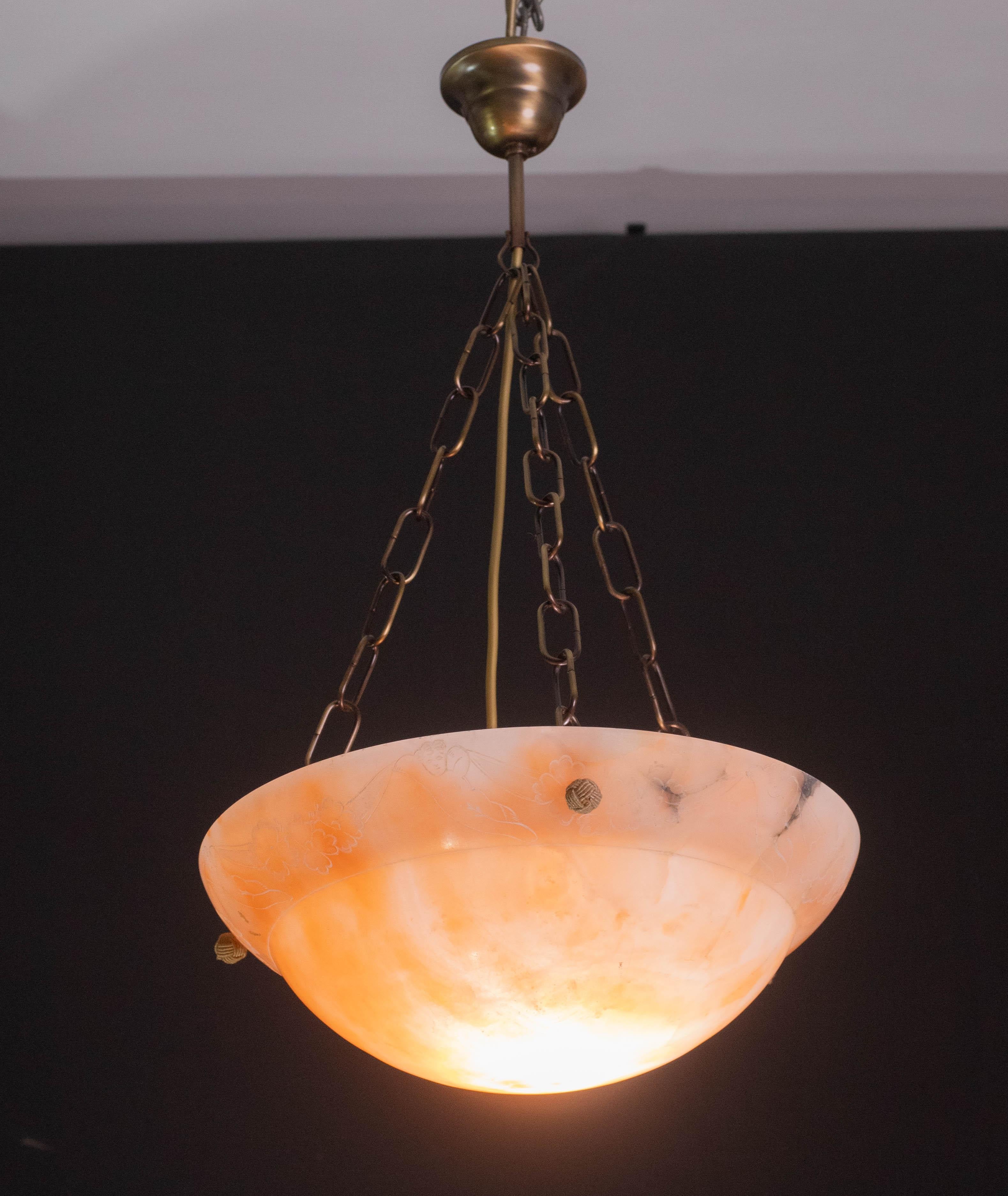 Antique alabaster hanging lamp in Art Deco style, circa 1940s.
A unique piece of alabaster, beautifully worked with unique decorations.
with shades and reflections of other colors when illuminated, the three original strings have been replaced with