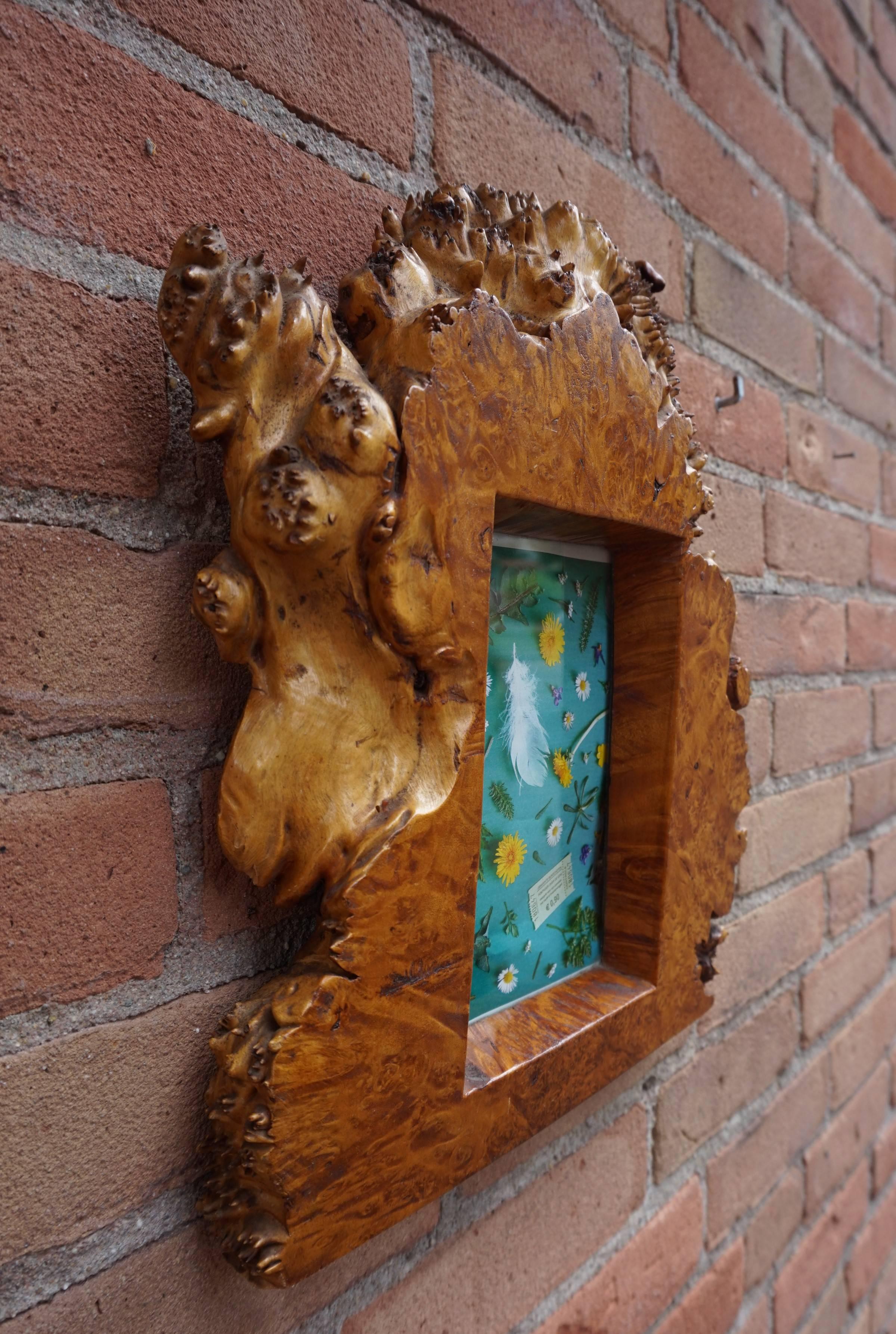 Wonderful and unique handcrafted burl frame.

This antique and beautifully organic frame is unlike anything you ever saw. This excellent condition picture frame is made out of one solid piece of burl and the natural color combined with the stunning