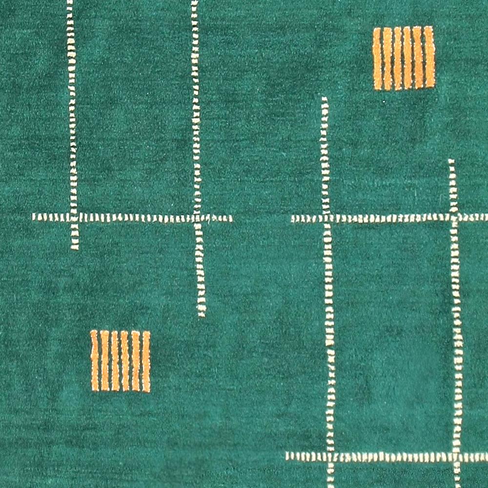 A very rare and unusual Indian carpet woven in the Art Deco period characterised by a blue-green background decorated geometric pattern consisting of asymmetrical rectangular units typical of the cubist-inspired rugs designed by Ivan Da Silva