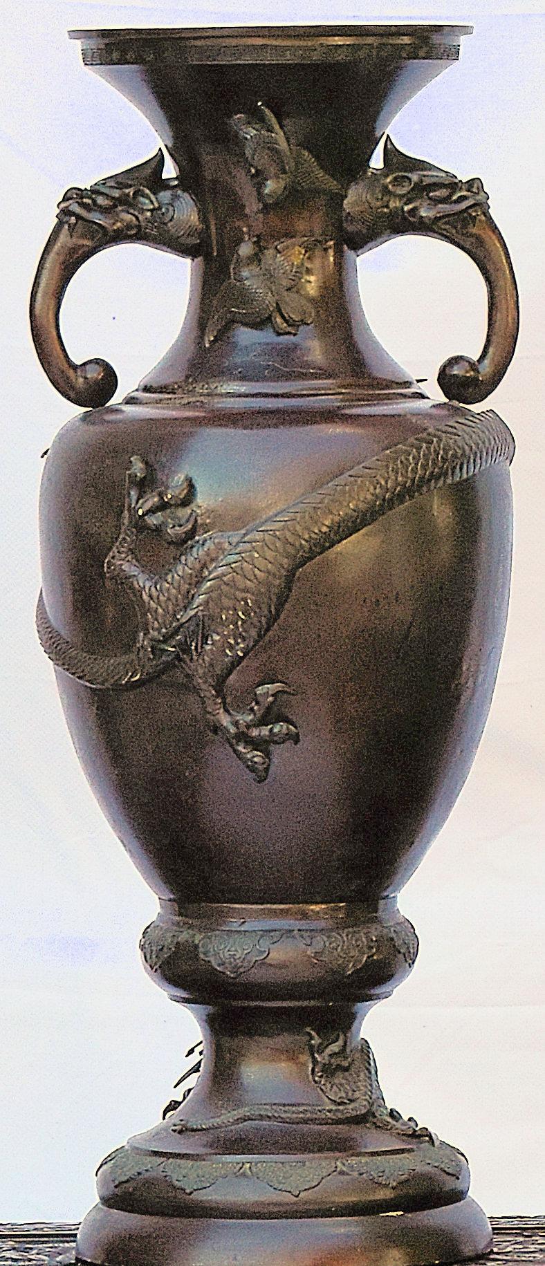 Chinese bronze altar vase decorated in the Archaistic style with mythical beast loop handles and a large dragon wrapping around the front of the vase.

bkx1