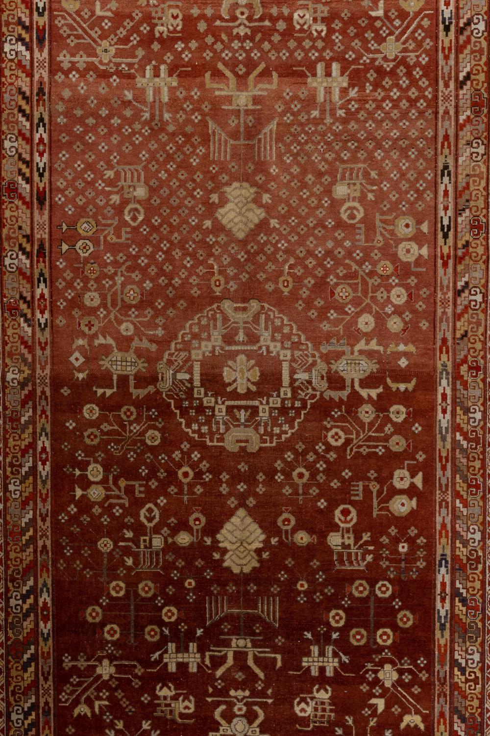 Age: Circa 1930

Colors: Sienna, black, tan

Pile: Medium

Wear Notes: 1 (slight fading consistent with age)

Material: Wool on Cotton. 

Antique Khotan rug with a high knot count and precise attention to detail. We love that with each