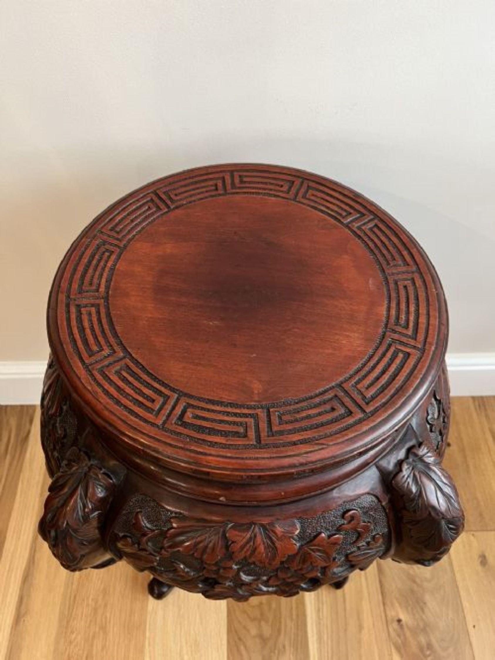 Antique oriental quality carved jardiniere stand having a quality carved circular top above a wonderful carved frieze with leaves and grapes standing on four shaped carved cabriole legs with scroll feet united by a carved circular under tier 