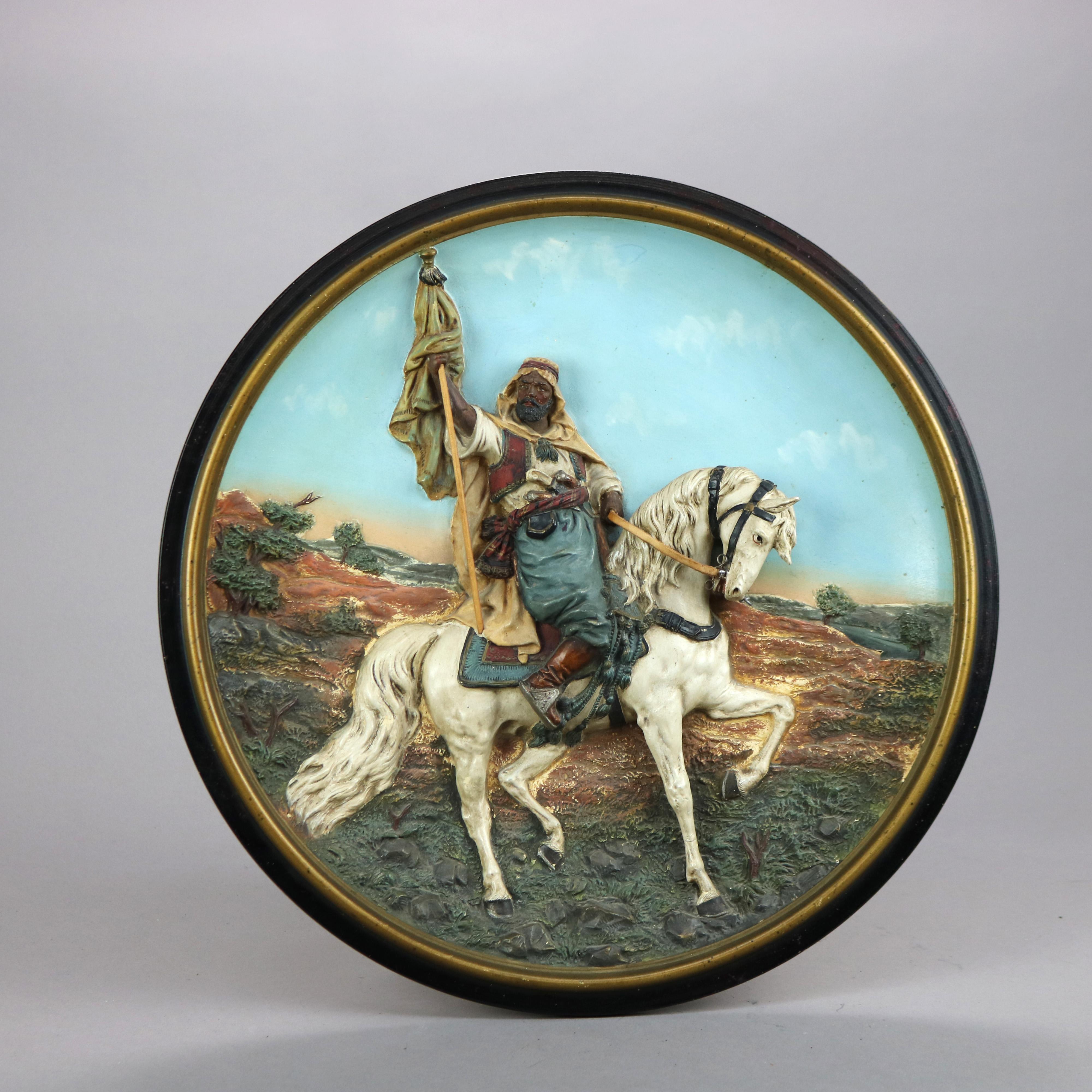 An antique German Amphora pottery charger by Musterschutz offers Moorish scene in relief with horse and rider, maker stamped en verso as photographed, c1910

Measures- 2.25'' H x 15.25'' W x 15.25'' D.

Catalogue Note: Ask about DISCOUNTED DELIVERY