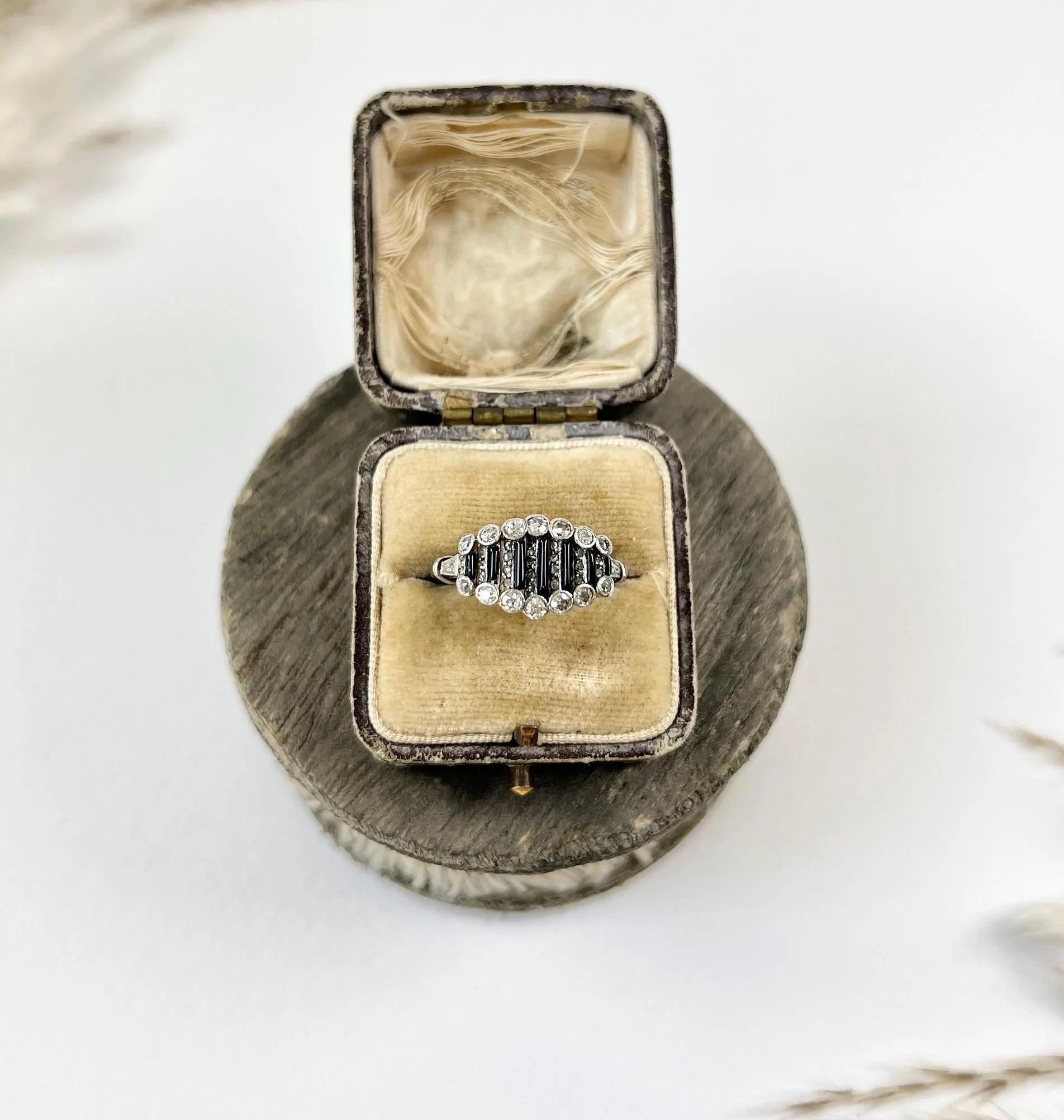 Art Deco Onyx Ring

Platinum

Circa 1920s

This stunning art deco cocktail ring features alternating bands of old-cut diamonds and onyx. The rose-cut diamonds are set in seven alternating vertical bands. The top and bottom of the ring are adorned