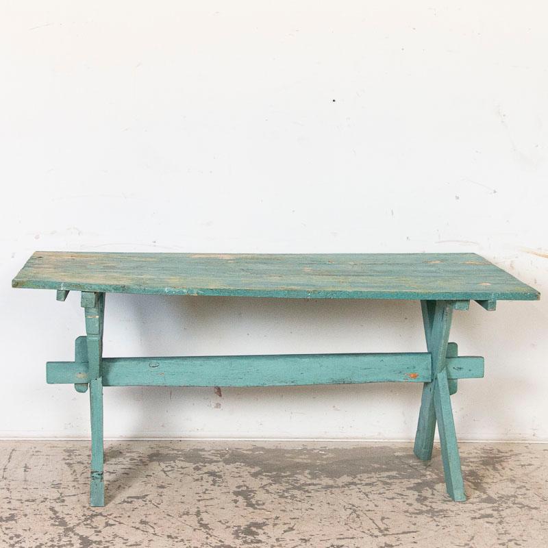 It is the vibrant aqua blue color that draws attention to this fun old farm table from Sweden. Upon closer examination(refer to photos), you will see a base layer of blue, with areas painted over with green and where both layers are worn off the
