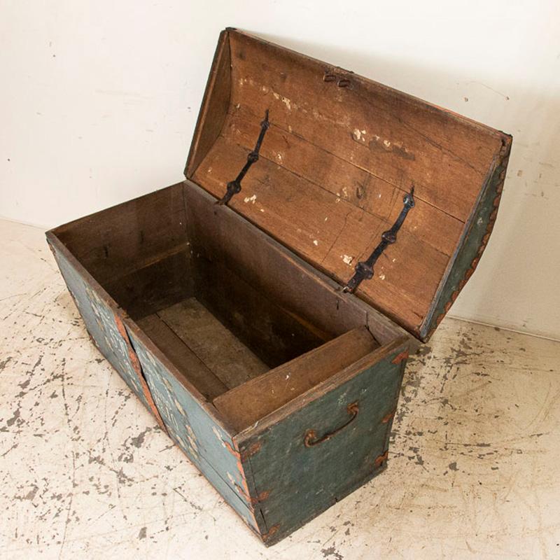 The soft blue paint is all original on this lovely dome top trunk from Sweden. The monogram of SMD and date of 1810 indicate it was likely a wedding present for a couple beginning their life together. Notice the beautiful garland of white flowers