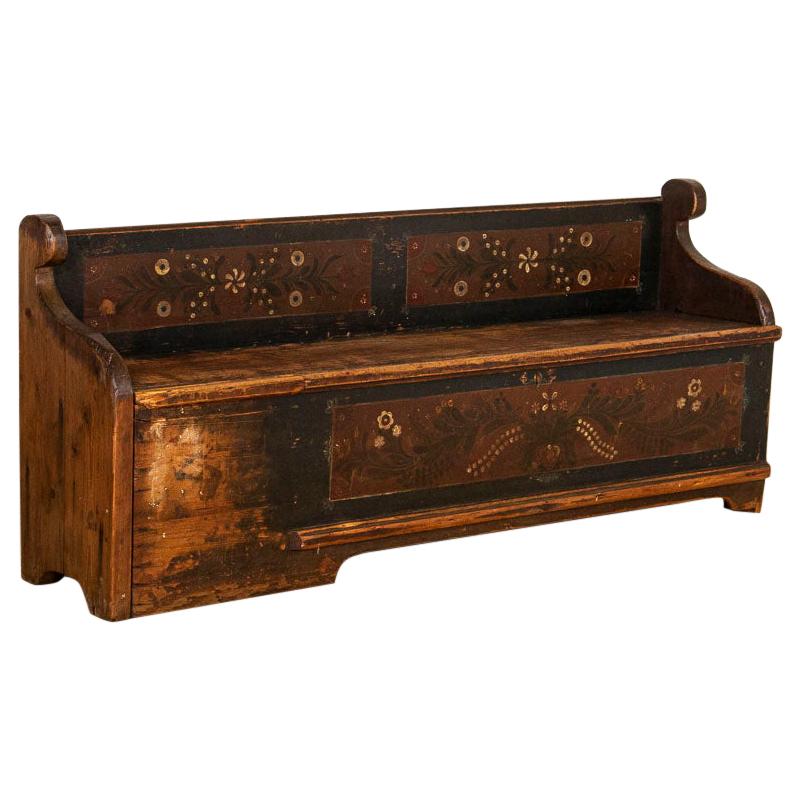 It is the original hand painted finish, worn dramatically over time yet whispering of days gone by that drawn one to sit and linger on this wonderful European country bench. Dark blue paint, accented with earth tones, dark, burnt red accented with