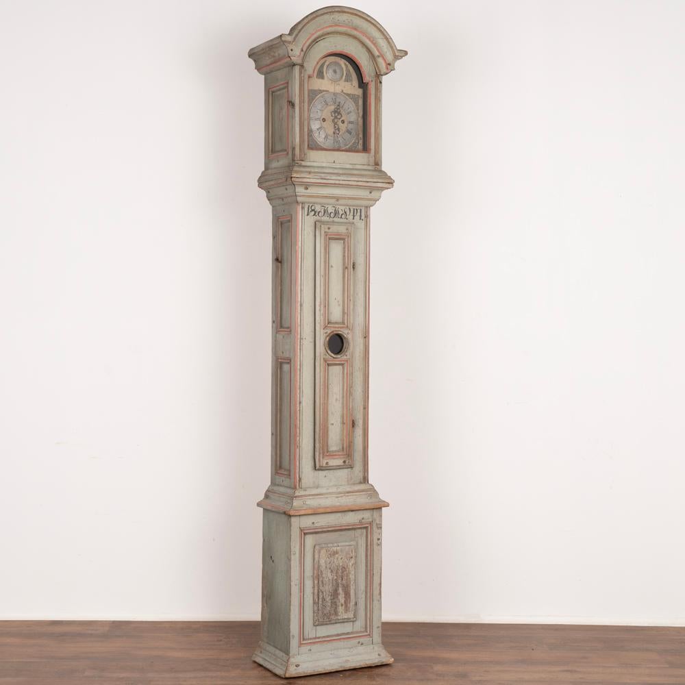 Hand painted grandfather clock with exceptional original soft blue painted finish accented in red trim.
Panel details, curved bonnet, slender case with lovely balance to face and base are all highlights of this wonderful original find.
Monogram of