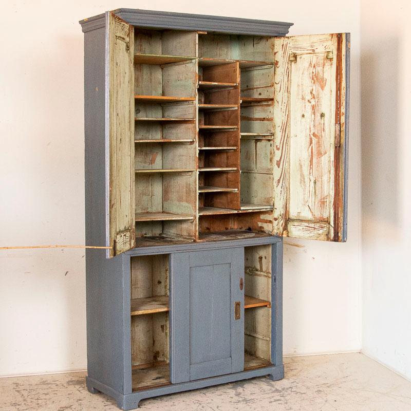 Both attractive and functional, you must see the interior of this blue painted storage cabinet to appreciate it fully. Notice the many shelves inside, allowing one to organize your office, crafts, sheets of music or other items well. The upper