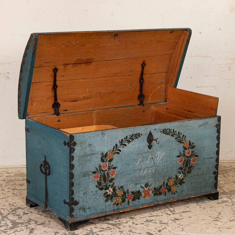This endearing Swedish dome top trunk is embedded with simple grace. The original blue painted finish with lovingly detailed flower wreath is just exquisite, including the perfectly aged patina that draws one to it. The detailed flower garland