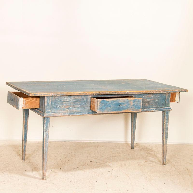 The perfect patina in the aged, blue painted finish shows off generations of use in this delightful farm table from Sweden. Notice the 3 usable drawers with hand-carved wooden pulls that add both function and charm and the traditional slender