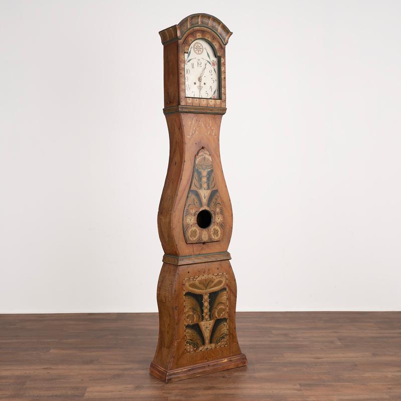 Antique Swedish Mora Grandfather clock with original paint, dated 1857.
Pine longcase with original folk art paint in traditional earth tones.
Original painted clock face and hands. 
Clock works do not function.
Longcase is restored and waxed, solid