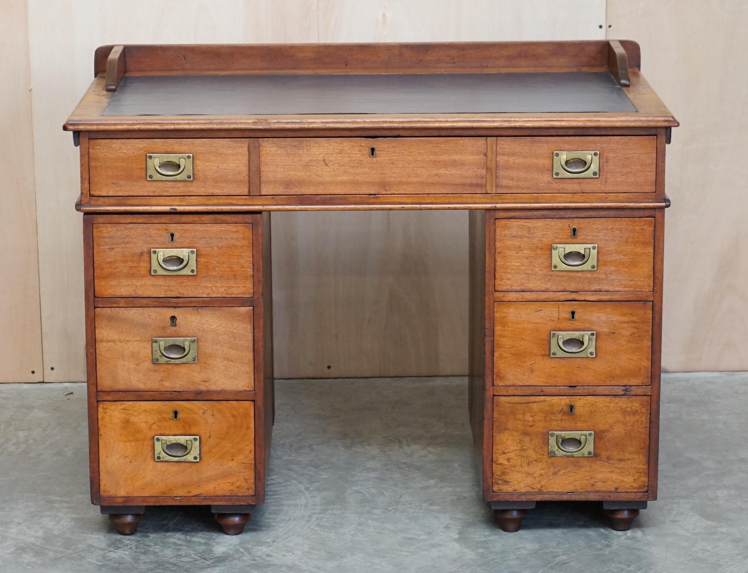 We are delighted to offer this very rare original Naval Military Campaign officers desk

This is a naval military desk, the top slots into little grooves at the back of each pedestal. The top drawer which looks to be three separate drawers is