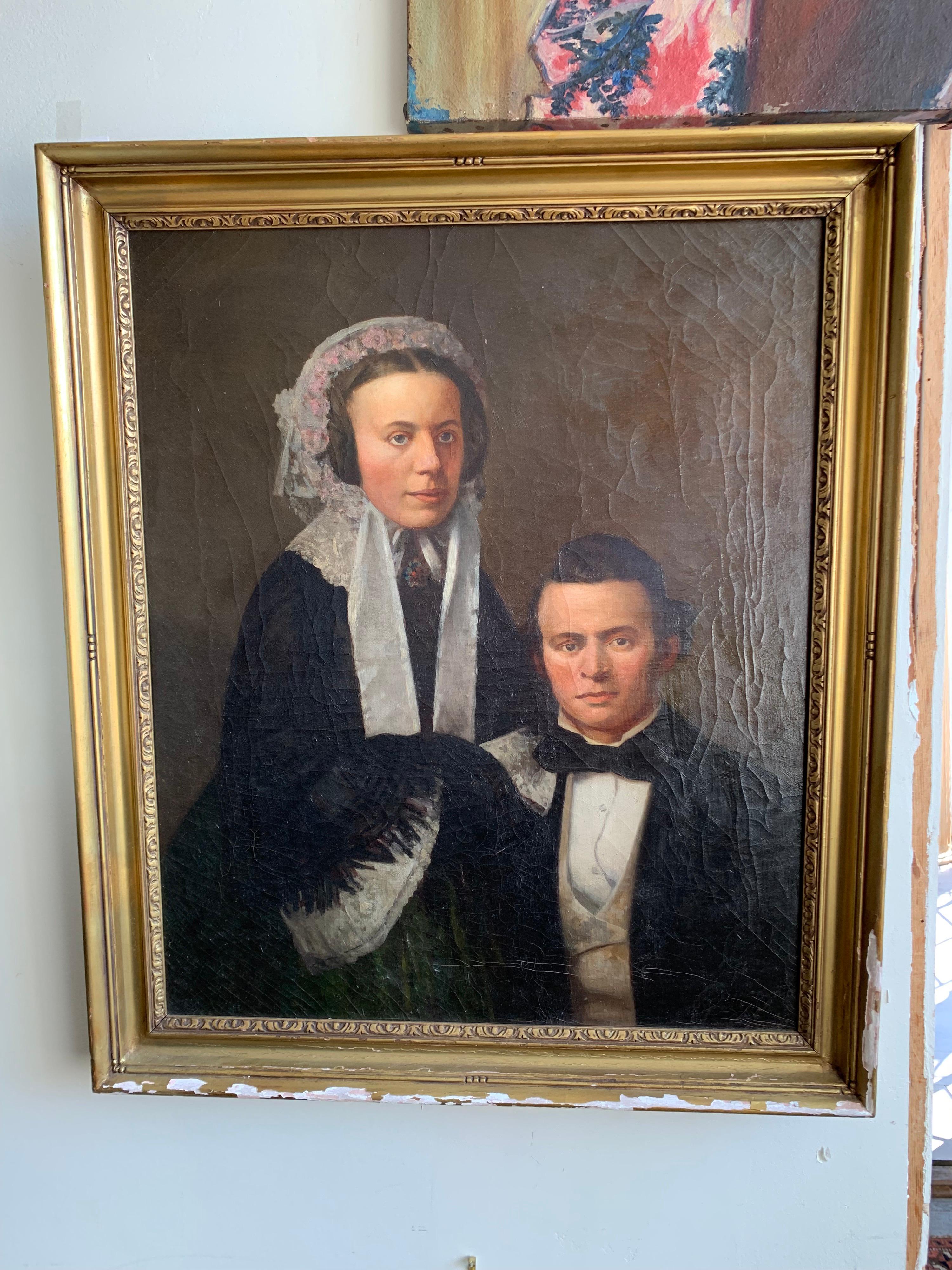 Early 19th century oil painting portrait of a seated man with a woman. They are dressed in formal attire with expressions that are almost detached. They both exude an air of grace and elegance. The painting is signed illegibly lower right and is