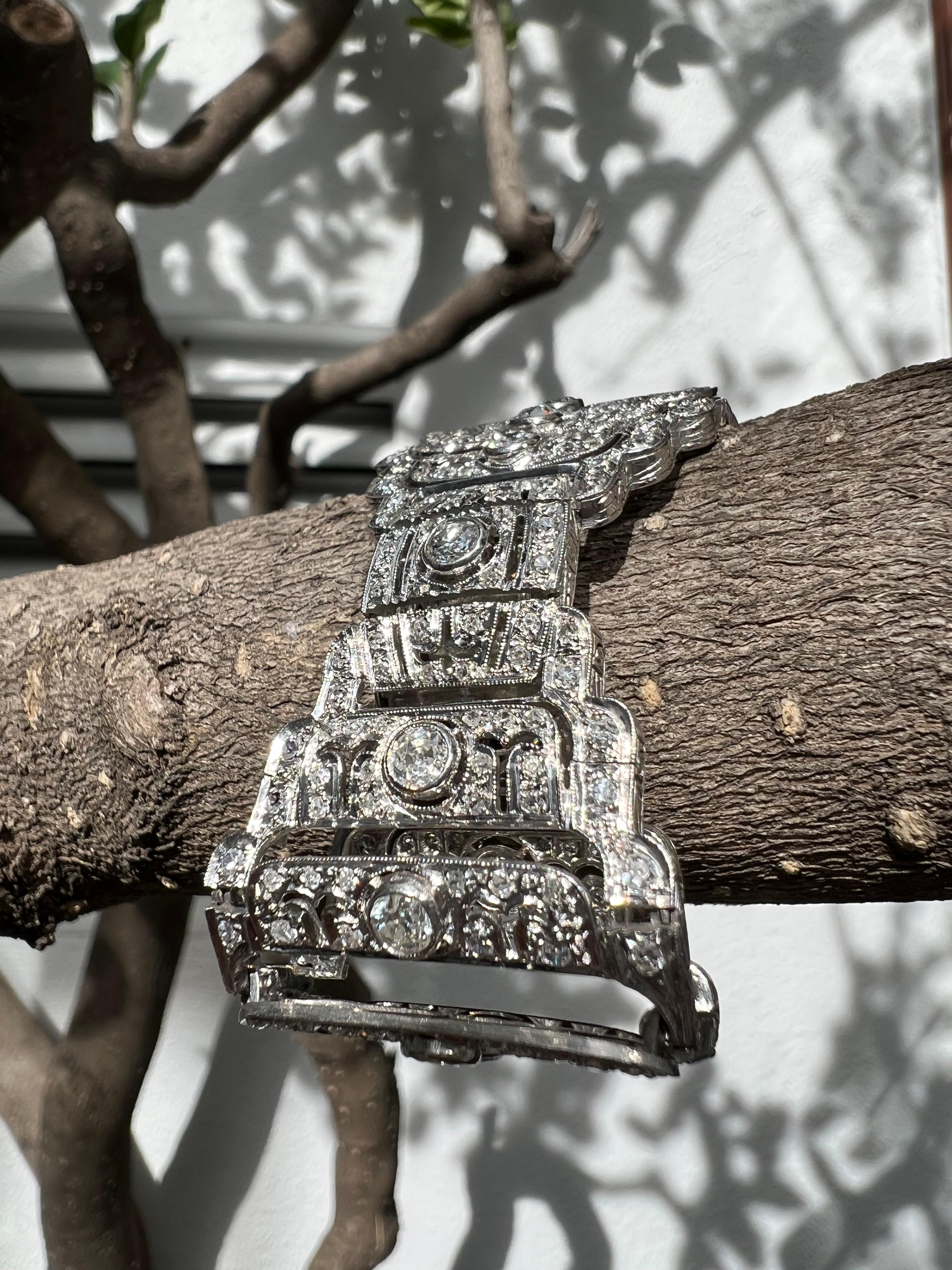 This antique French Art-Deco piece is truly spectacular. Unlike many re-productions, this is a genuine French art-deco Diamond and platinum bracelet from the 1920’s. 

There are about 7.44 carats of diamonds. Each of the larger stones are Old