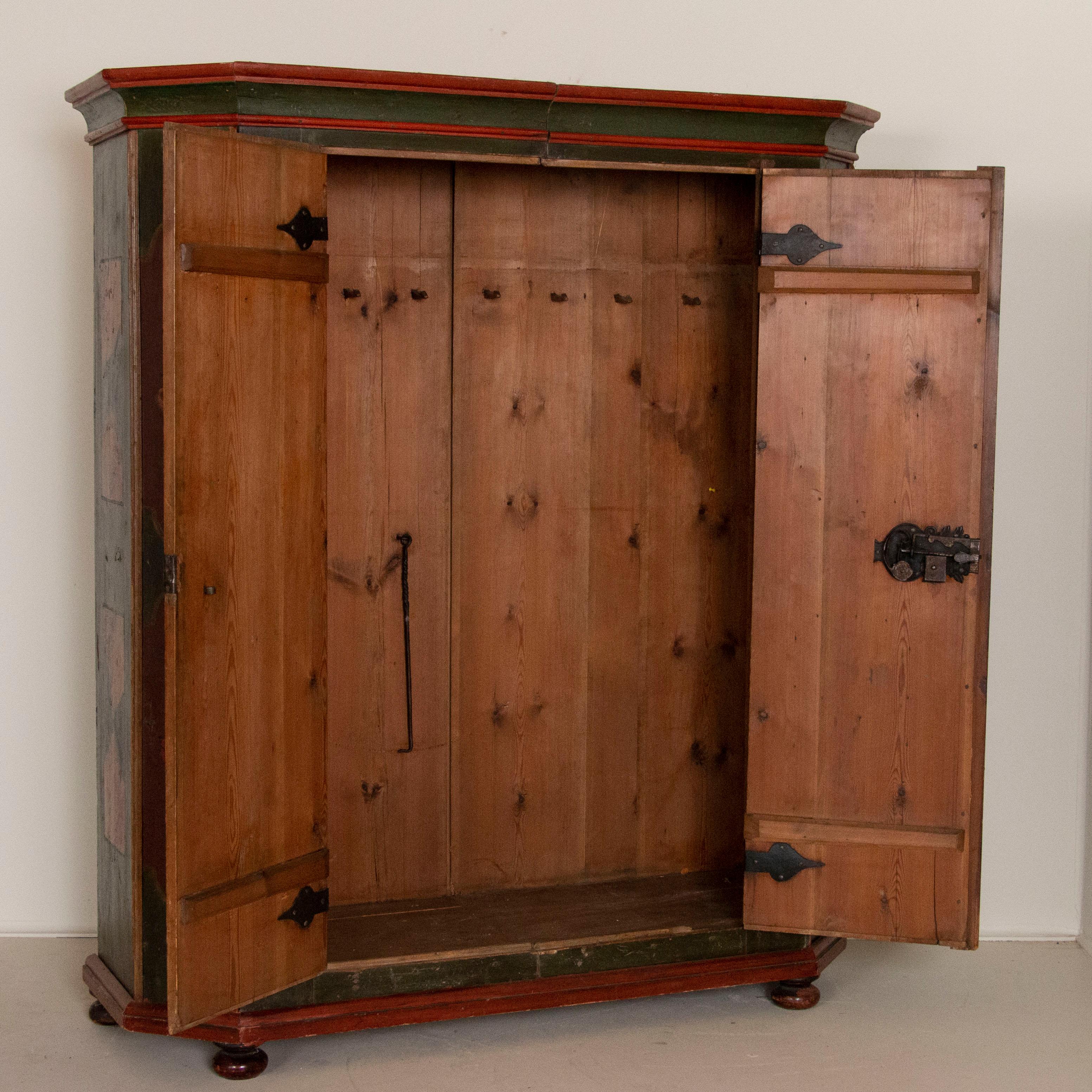 The date of 1790 speaks to the remarkable age of this beautiful armoire, while the original green and red paint has deepened and grown richer over time. Even the natural pine interior has deepened to a rich patina, reflective of the passage of many