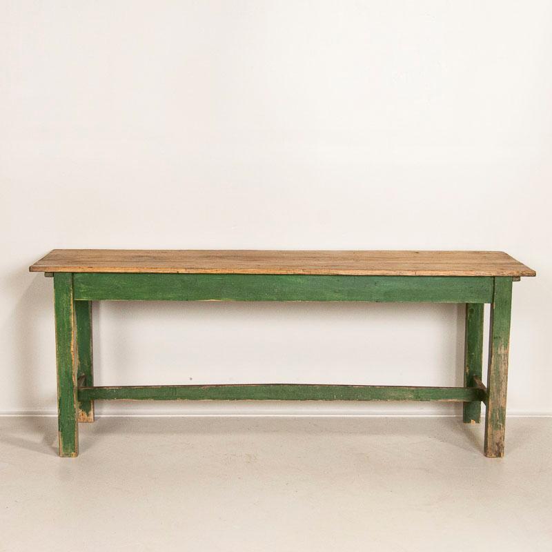 For those who search for a genuine European country farm table this 6 1/2' green painted harvest table is a fun find. The wonderful, age-distressed green paint of the trestle base is all original, and is complimented by the pine plank top that has