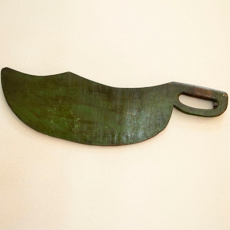 Antique original green painted Swedish scutching knife with simplistic hand painted vine details and the date of 1872. This Swedish hand-carved farm tool was used during the flax harvest season, but the hand painted details raised it from a tool to