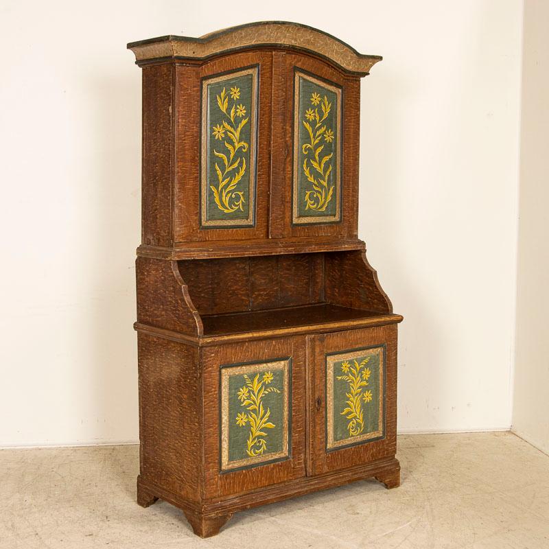 We continually search for original painted antique Swedish furniture as they have become more difficult to find. This cupboard is special due it its original condition. The painted faux wood background was the traditional folk art of the period and