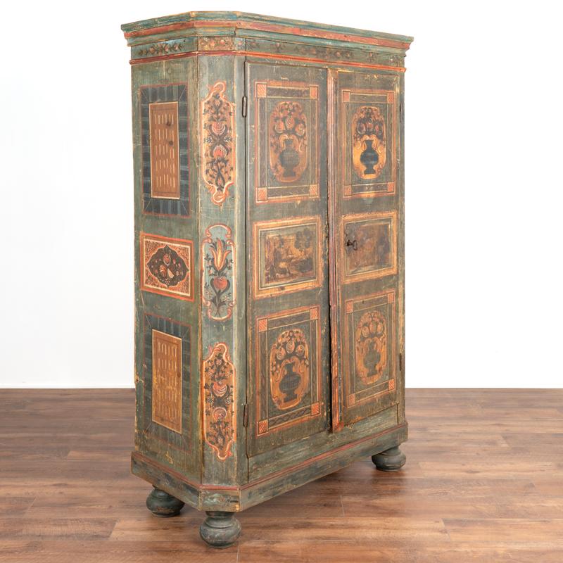This lovely painted armoire still maintains the quality and details of the original hand-painted finish. The soft, gentle colors with delightful floral and pastoral motifs are beautifully executed. Notice the 6 panels of flowers against the soft