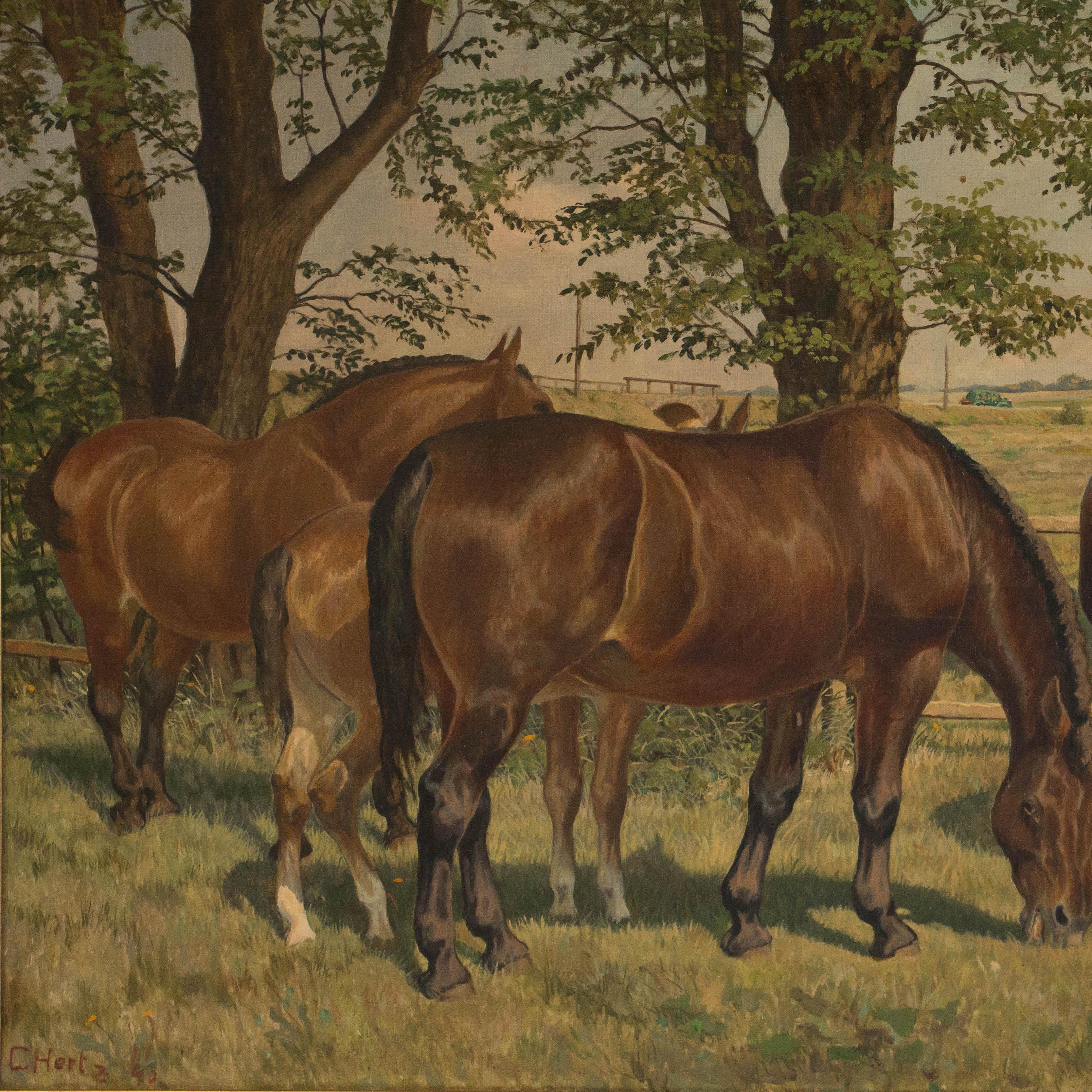 This original early 20th century landscape oil painting, with lots of detail, features a small herd of horses in a grassy field. Mounted in a gold painted frame, the painting is signed and dated C Hertz '40 in the lower left by Danish artist Carl