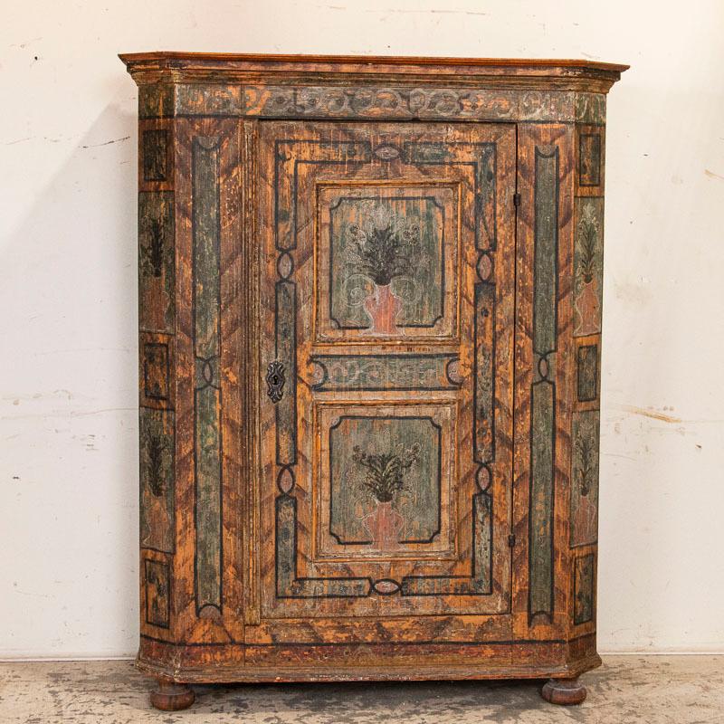 It is always a joy to discover a truly beautiful, original painted armoire and this one is an exceptional find. The skill of the painter is still seen today, revealed in the soft colors and wonderful detail in the flowers, scrolling flourishes and