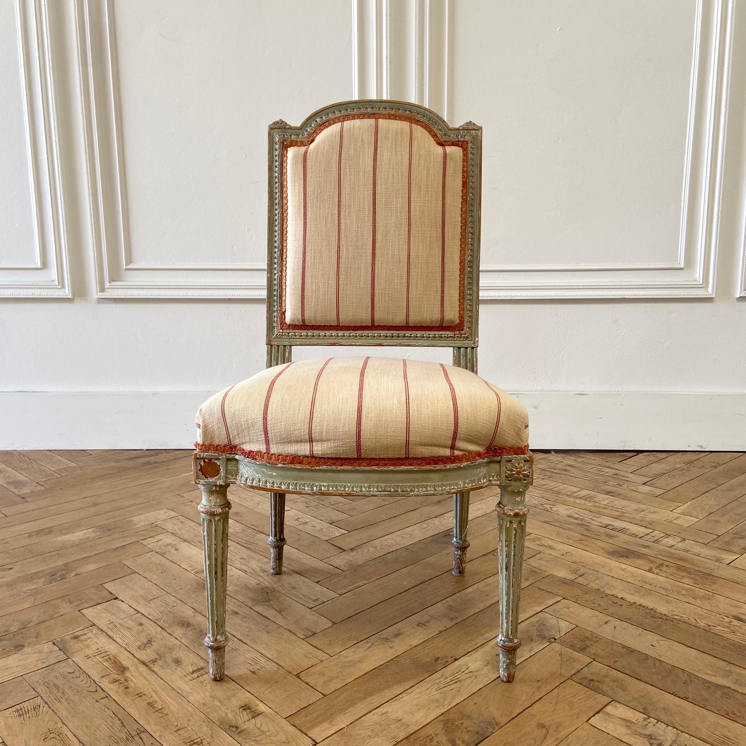 Beautiful painted Louis XVI style chair with upholstered seat and back.
The faded painted finish is original, in a french gray-blue green color, with exposed wood. Can be reupholstered for an additional fee.

Antique accent chair 19”W x 21”D x