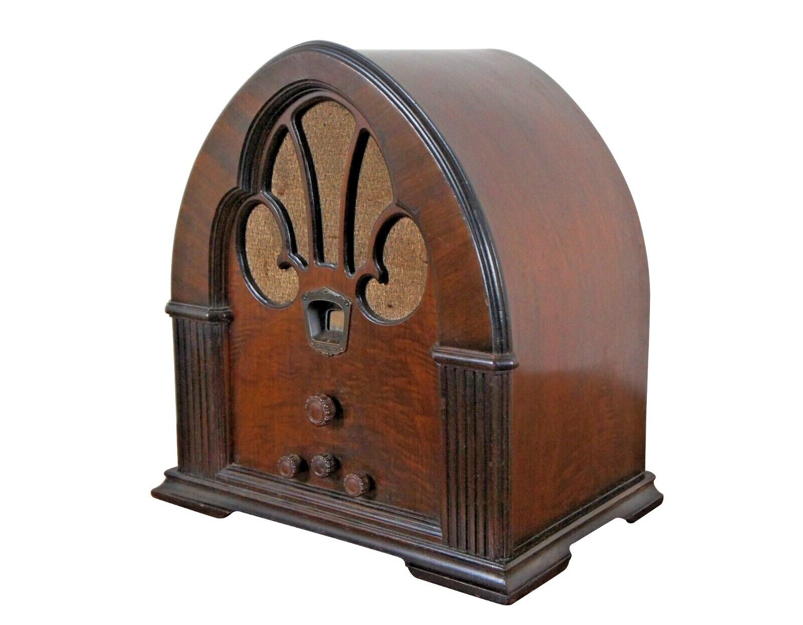 Antique Philco Model 90 Baby Grand Super Heterodyne radio featuring a cathedral style walnut cabinet / case, molded rosette style Bakelite knobs, and golden beige grill cloth.

Referred to as 