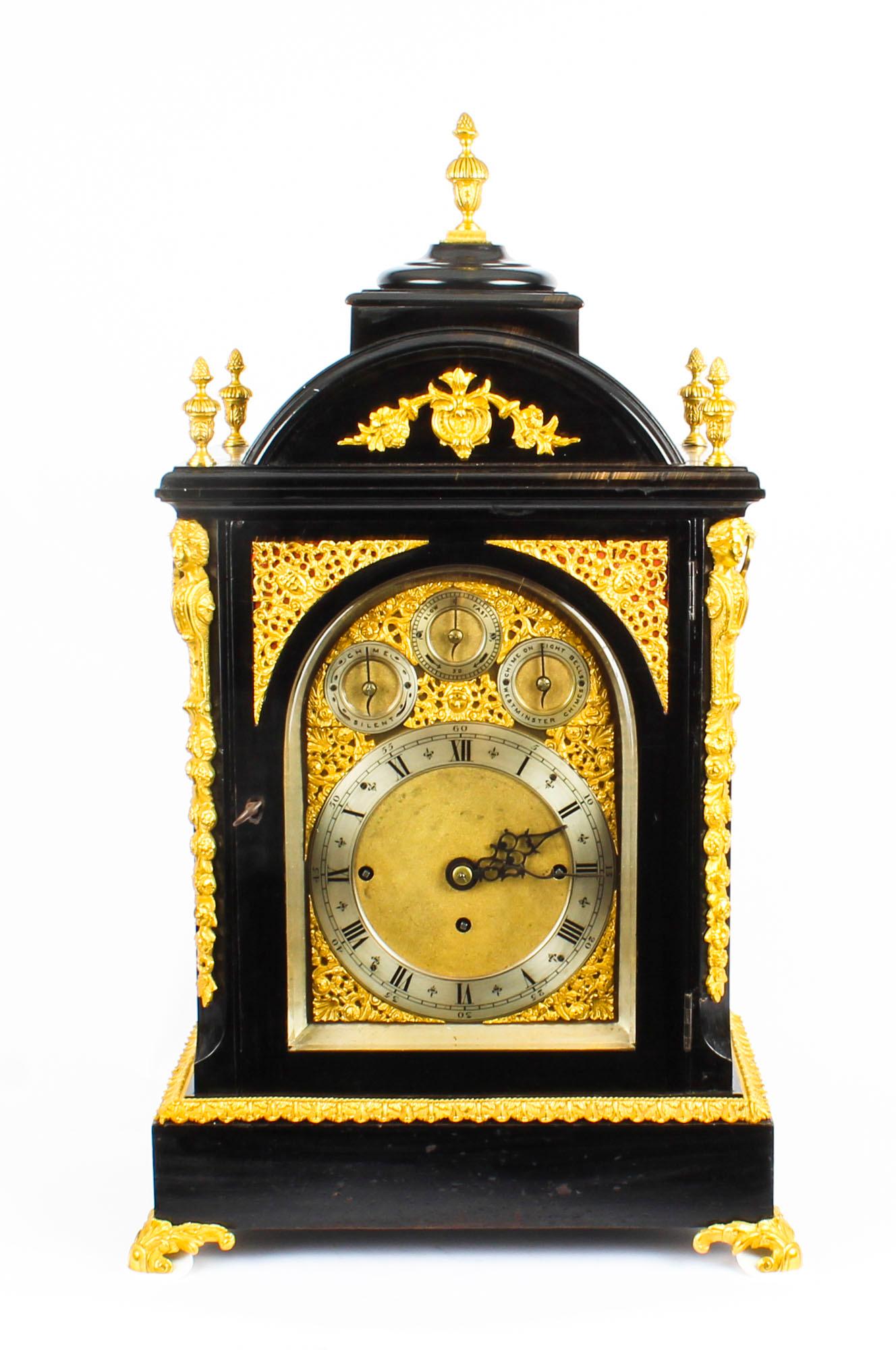 A stunning 19th century ormolu-mounted ebonised three train bracket clock, of large size. 

The caddy top case decorated with five flaming urn finials and ribbon-tied foliate festoons, above an arched cast brass glazed door. This is flanked by a